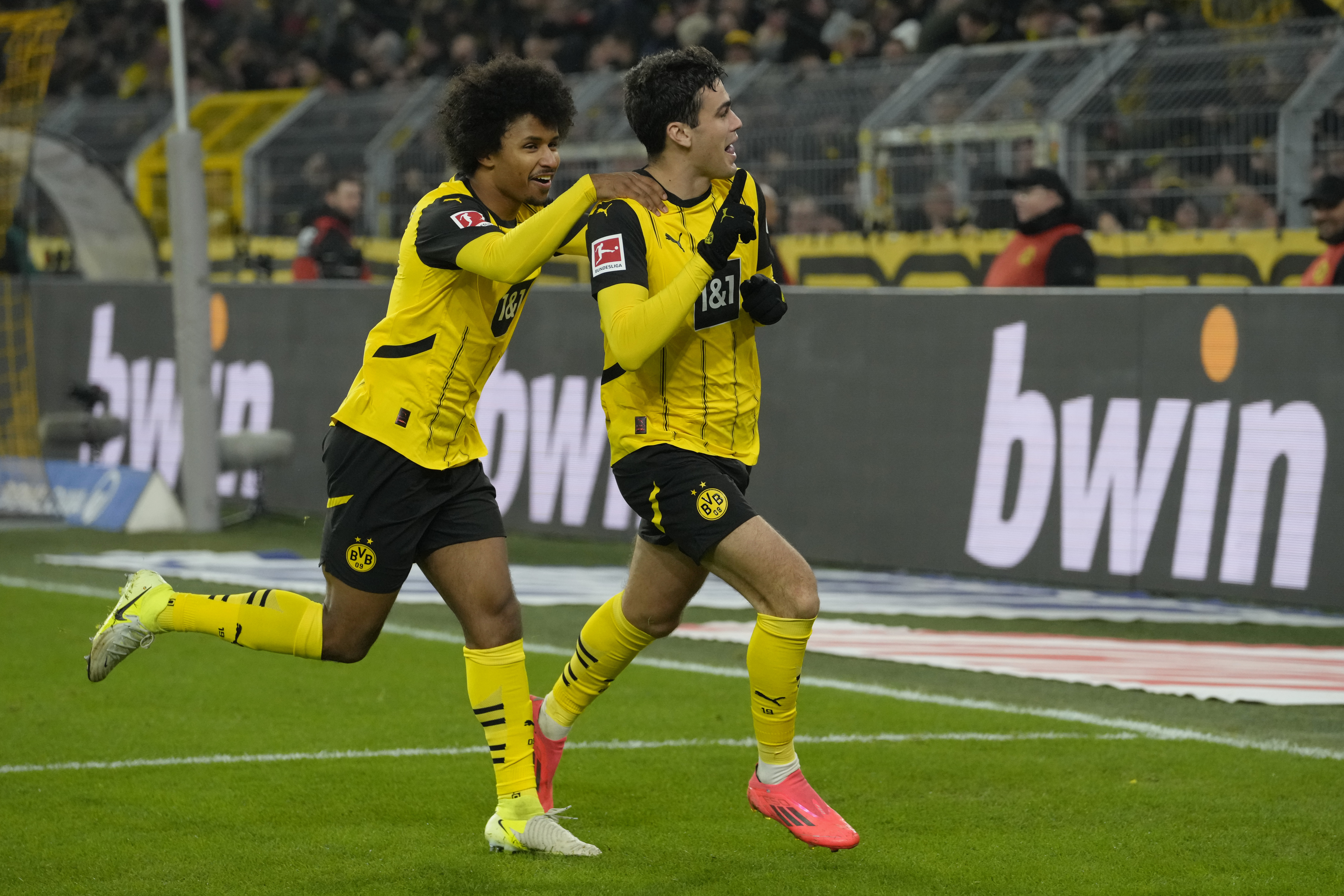 Dortmund's Giovanni Reyna, right, celebrates with teammate Karim Adeyemi after scoring the opening goal during the German Bundesliga soccer match between Borussia Dortmund and TSG Hoffenheim at the Signal-Iduna Park in Dortmund, Germany, Sunday, Dec. 15 2024.