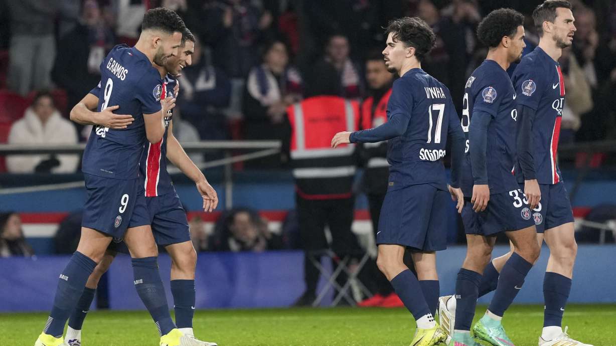 PSG's Goncalo Ramos, left, celebrates with teammates after scoring his side's third goal during the French League One soccer match between Paris Saint-Germain and Lyon at the Parc des Princes in Paris, Sunday, Dec. 15, 2024.