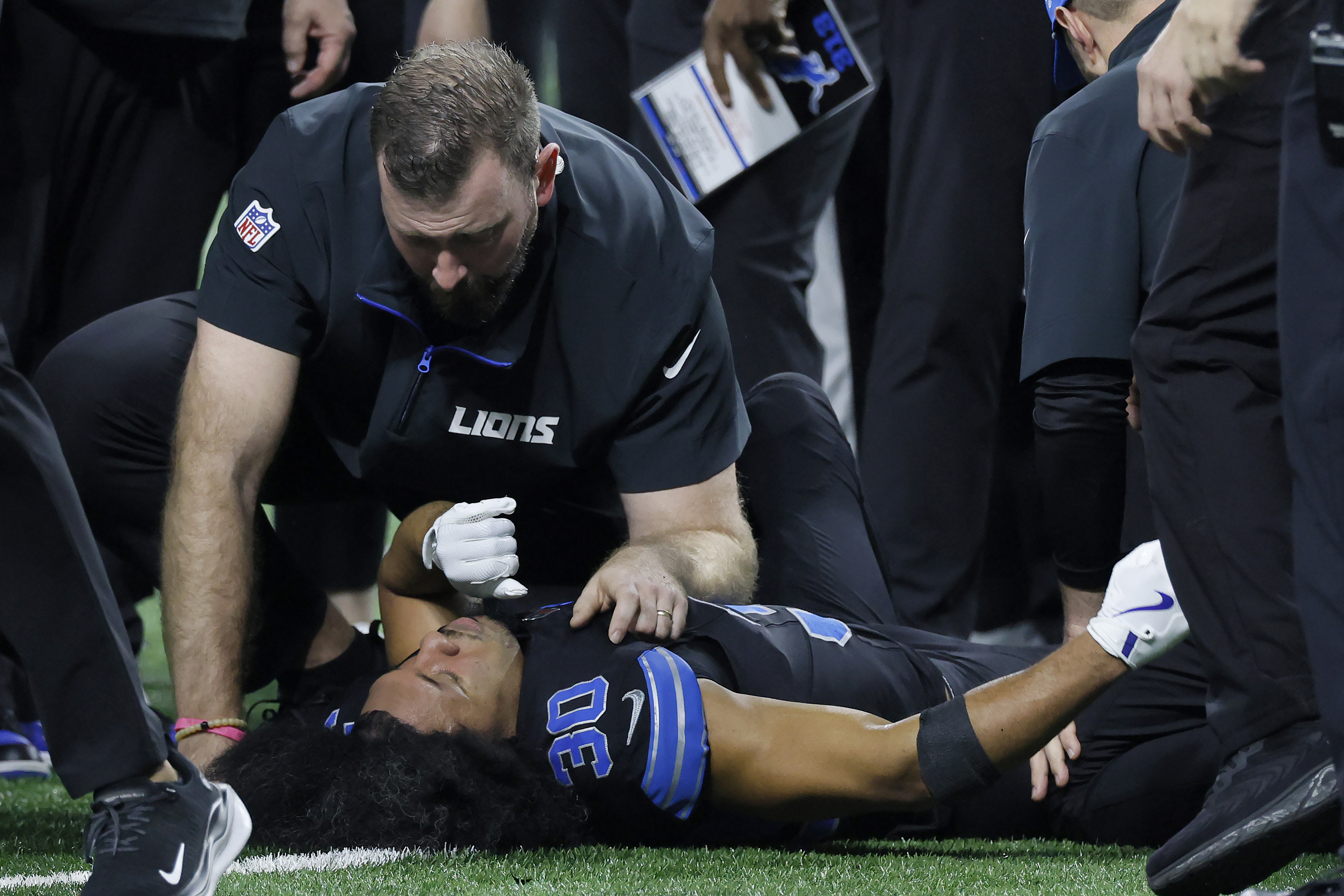 Trainers check on Detroit Lions cornerback Khalil Dorsey (30) during the first half of an NFL football game against the Buffalo Bills, Sunday, Dec. 15, 2024, in Detroit.