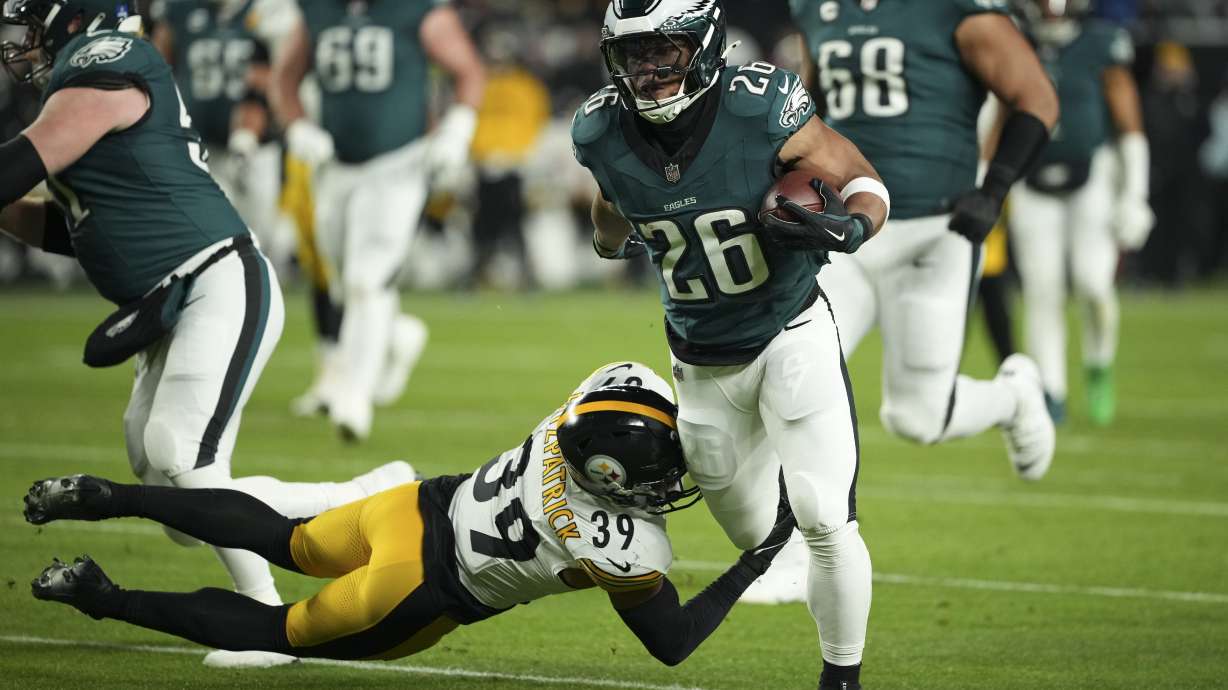 Philadelphia Eagles running back Saquon Barkley (26) runs with the ball as Pittsburgh Steelers safety Minkah Fitzpatrick (39) tries to stop him during the first half of an NFL football game Sunday, Dec. 15, 2024, in Philadelphia.