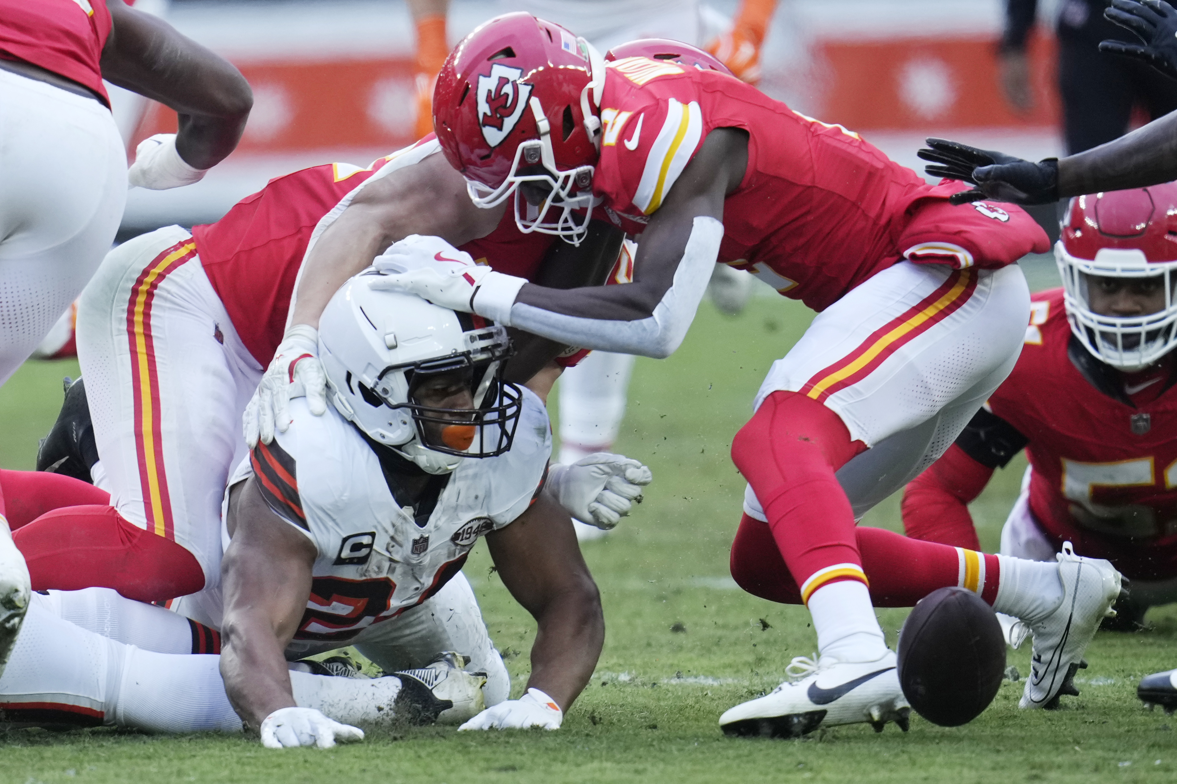 Cleveland Browns running back Nick Chubb, left, watches the ball after his fumble in the second half of an NFL football game against the Kansas City Chiefs in Cleveland, Sunday, Dec. 15, 2024. Chiefs' Joshua Williams (2) has his hand on Chubb's helmet. 