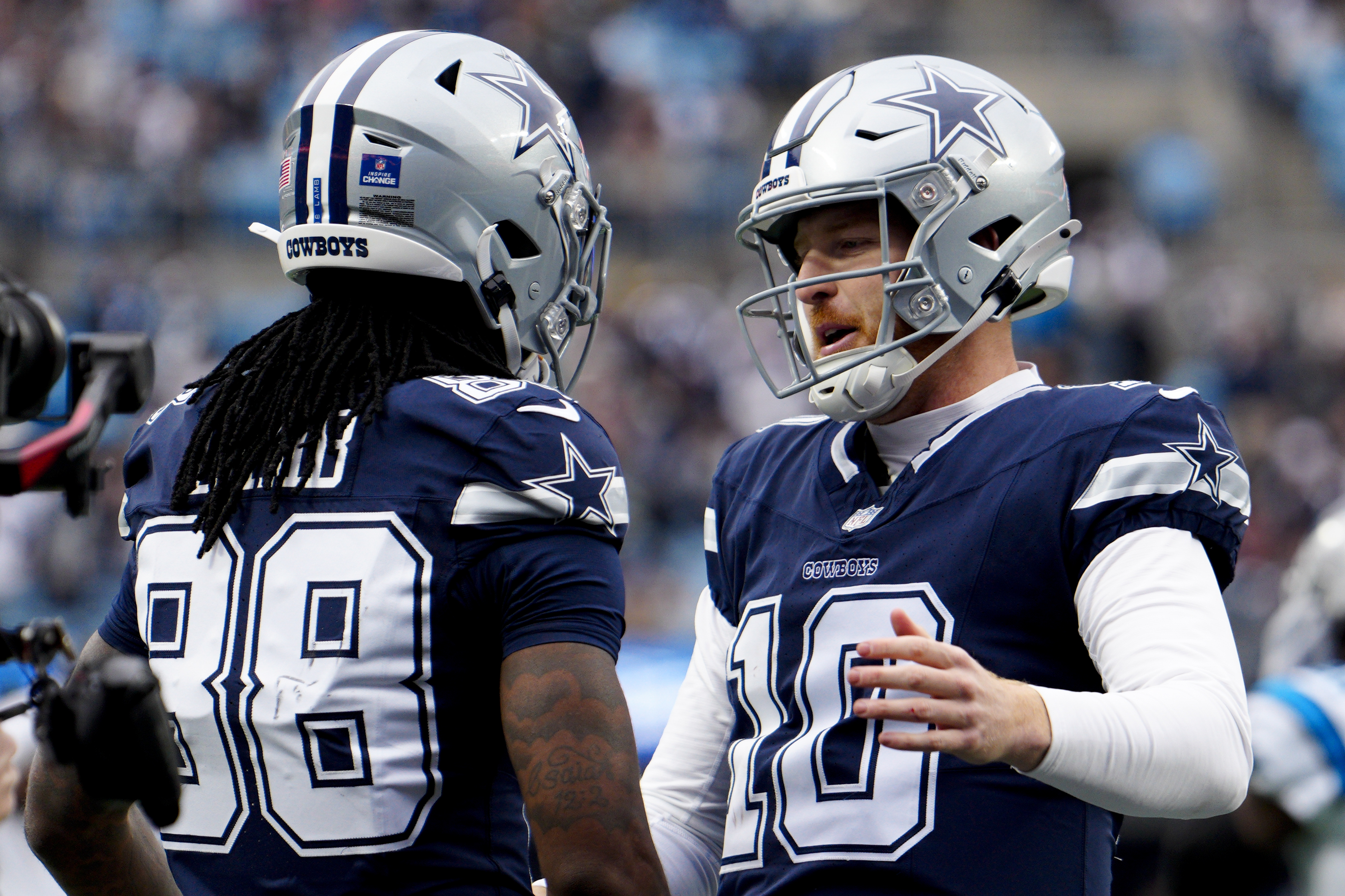 Dallas Cowboys wide receiver CeeDee Lamb celebrates after scoring with quarterback Cooper Rush against the Carolina Panthers during the first half of an NFL football game, Sunday, Dec. 15, 2024, in Charlotte, N.C. 