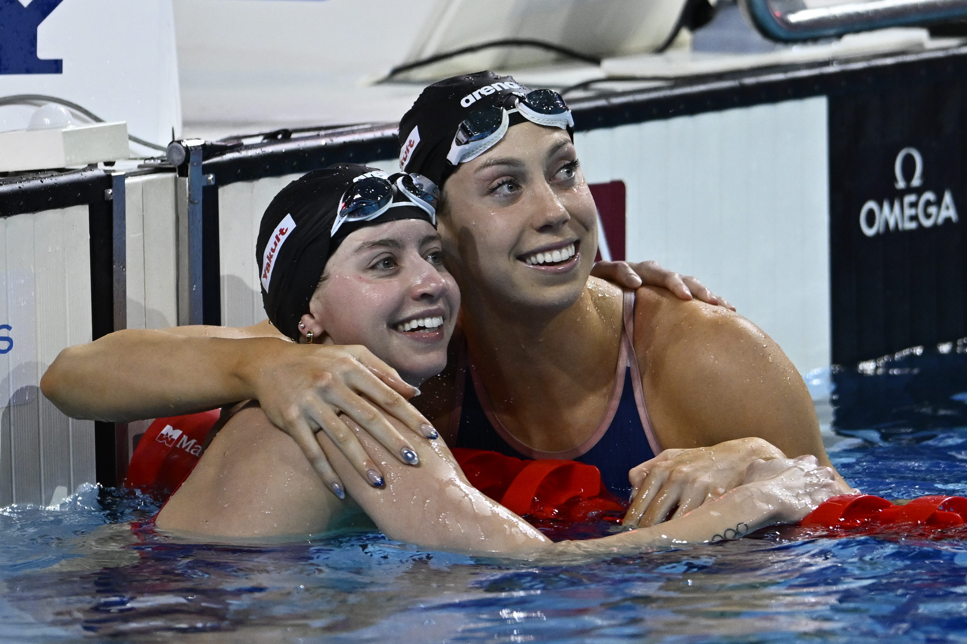 Second-placed Kate Douglass, left, and first-placed Gretchen Walsh, both from the United States, look at the scoreboard after the 50-meter freestyle al at the World Short Course Swimming Championships in Budapest, Hungary, Sunday, Dec. 15, 2024.