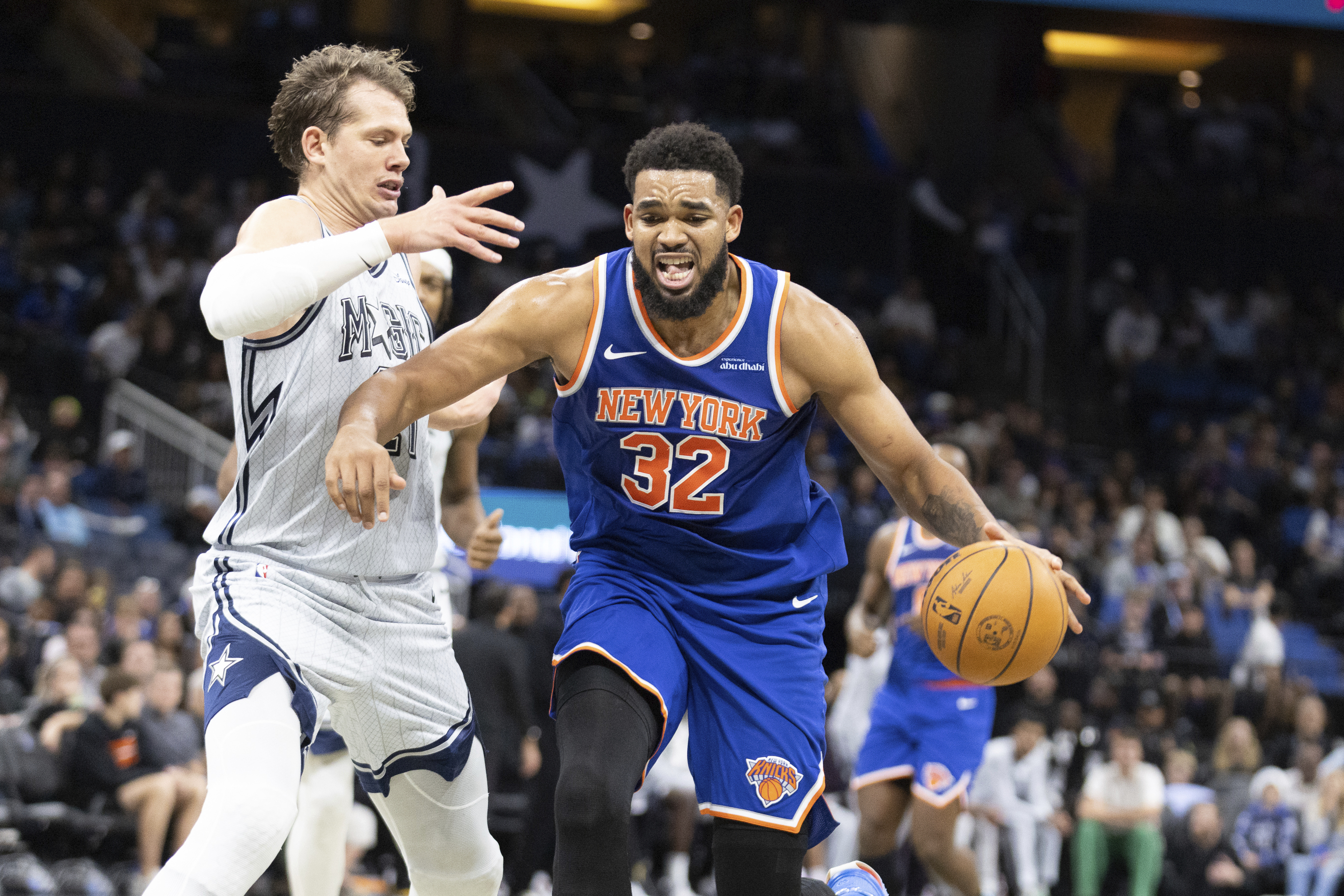 New York Knicks center Karl-Anthony Towns (32) drives against Orlando Magic center Moritz Wagner, left, during the first half of an NBA basketball game Sunday, Dec. 15, 2024, in Orlando, Fla. 