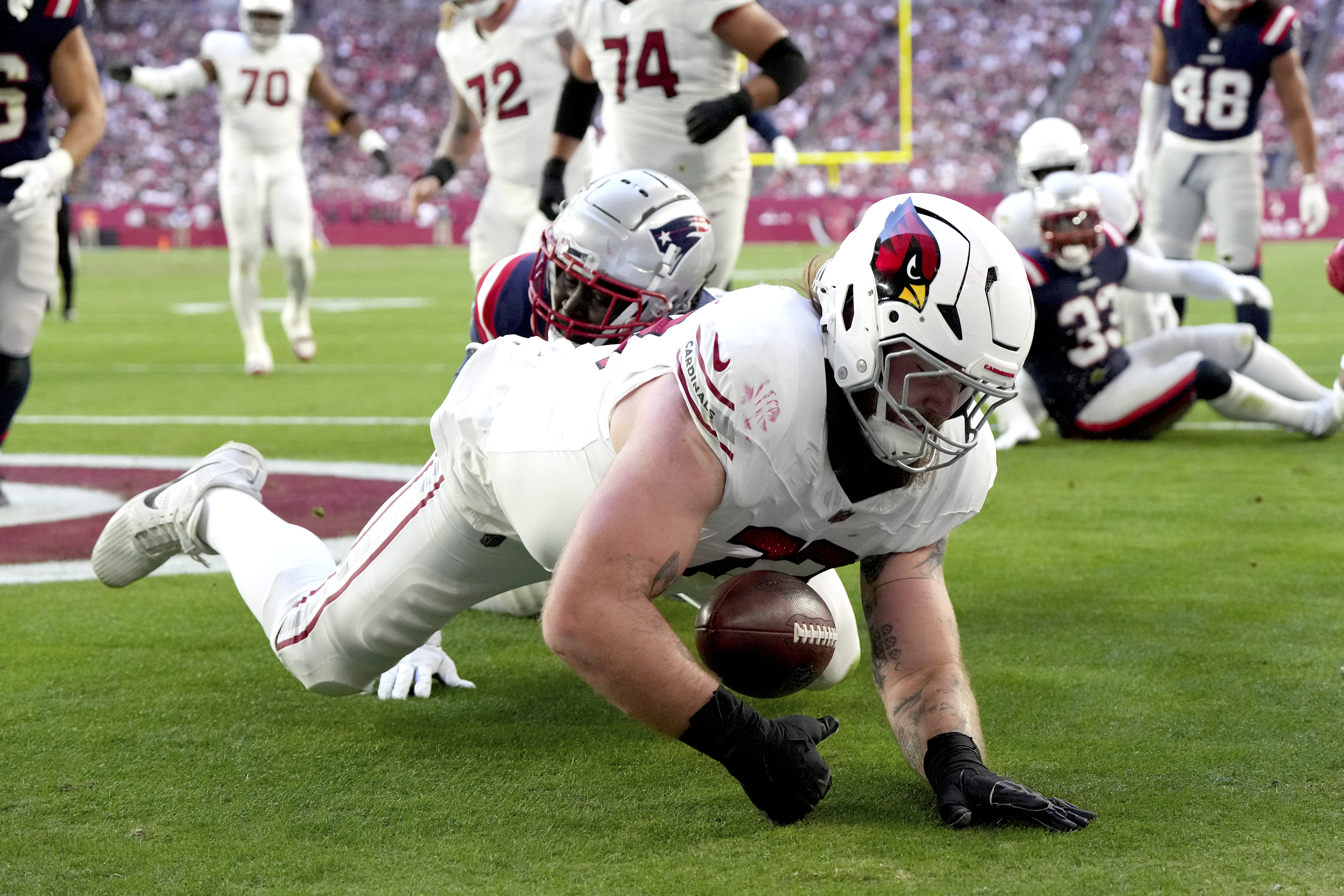 Arizona Cardinals offensive tackle Jonah Williams recovers a fumble for a touchdown against the New England Patriots during the first half of an NFL football game, Sunday, Dec. 15, 2024, in Glendale, Ariz. 