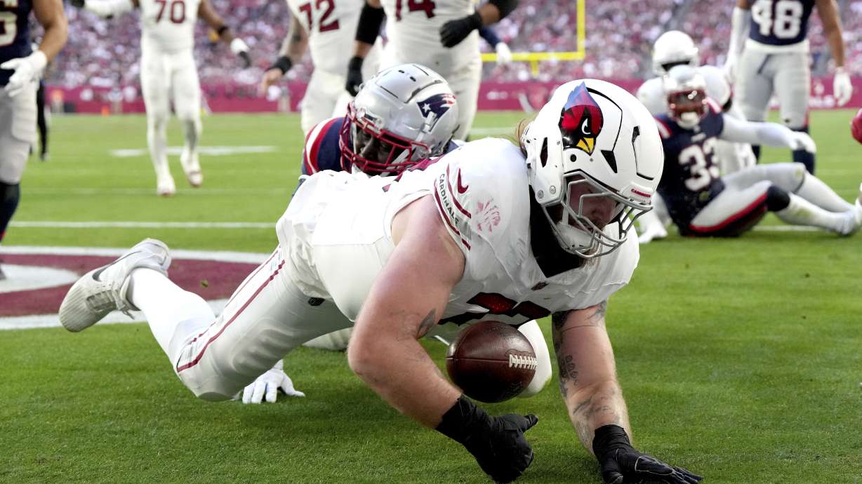 Arizona Cardinals offensive tackle Jonah Williams recovers a fumble for a touchdown against the New England Patriots during the first half of an NFL football game, Sunday, Dec. 15, 2024, in Glendale, Ariz.