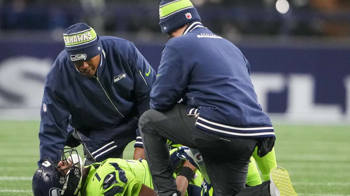 Seattle Seahawks' Geno Smith is hurt during the second half of an NFL football game against the Green Bay Packers Sunday, Dec. 15, 2024, in Seattle.