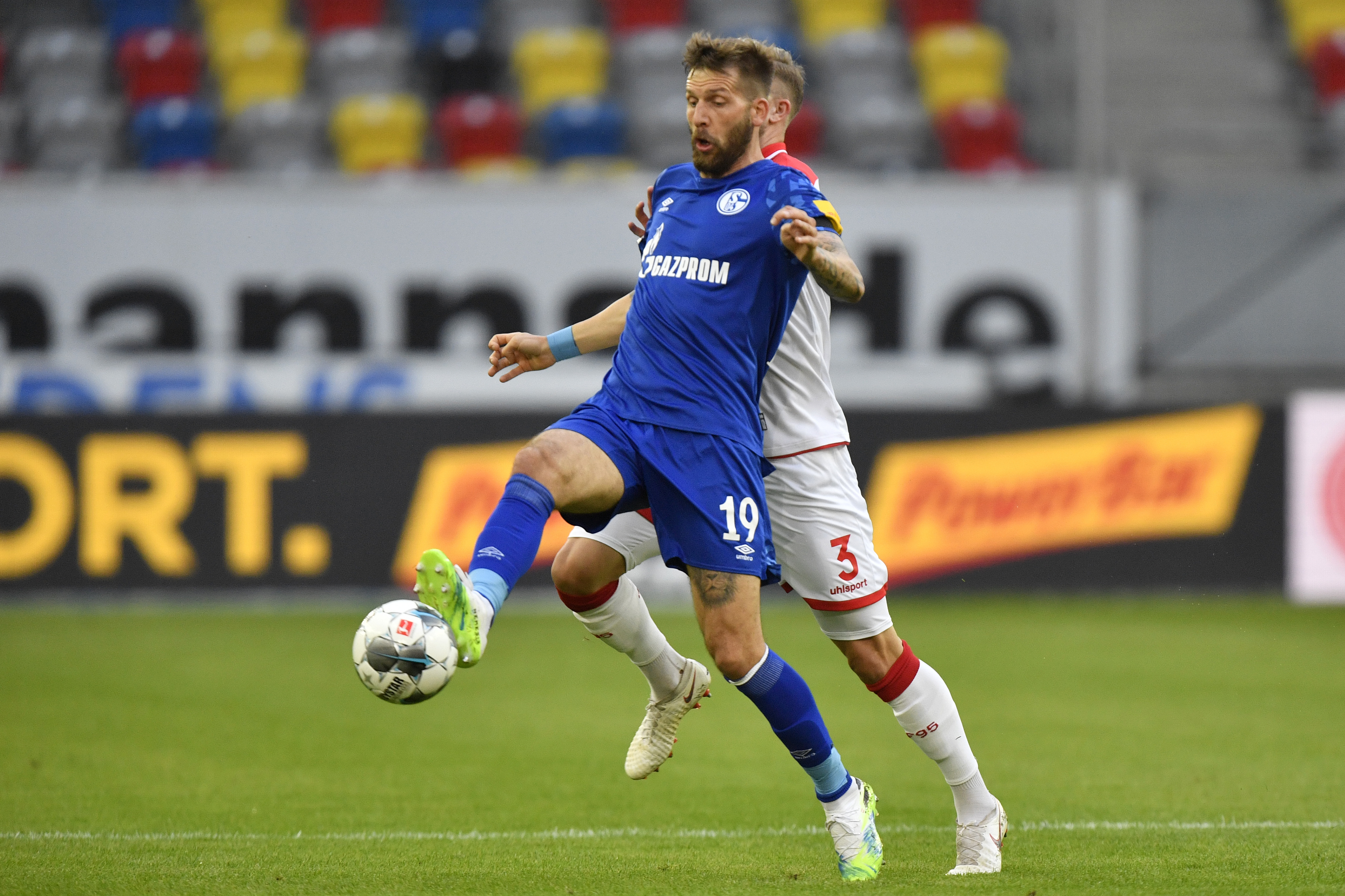 FILE - Schalke's Guido Burgstaller, left, is challenged by Duesseldorf's Andre Hoffman during the German Bundesliga soccer match between Fortuna Duesseldorf and FC Schalke 04 in Duesseldorf, Germany, on May 27, 2020. 