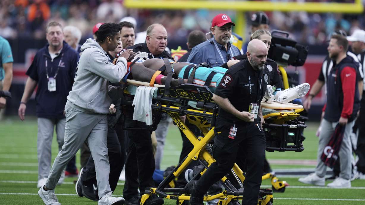 Miami Dolphins wide receiver Grant DuBose (88) is carted off the field after being injured during the second half of an NFL football game against the Houston Texans, Sunday, Dec. 15, 2024, in Houston.
