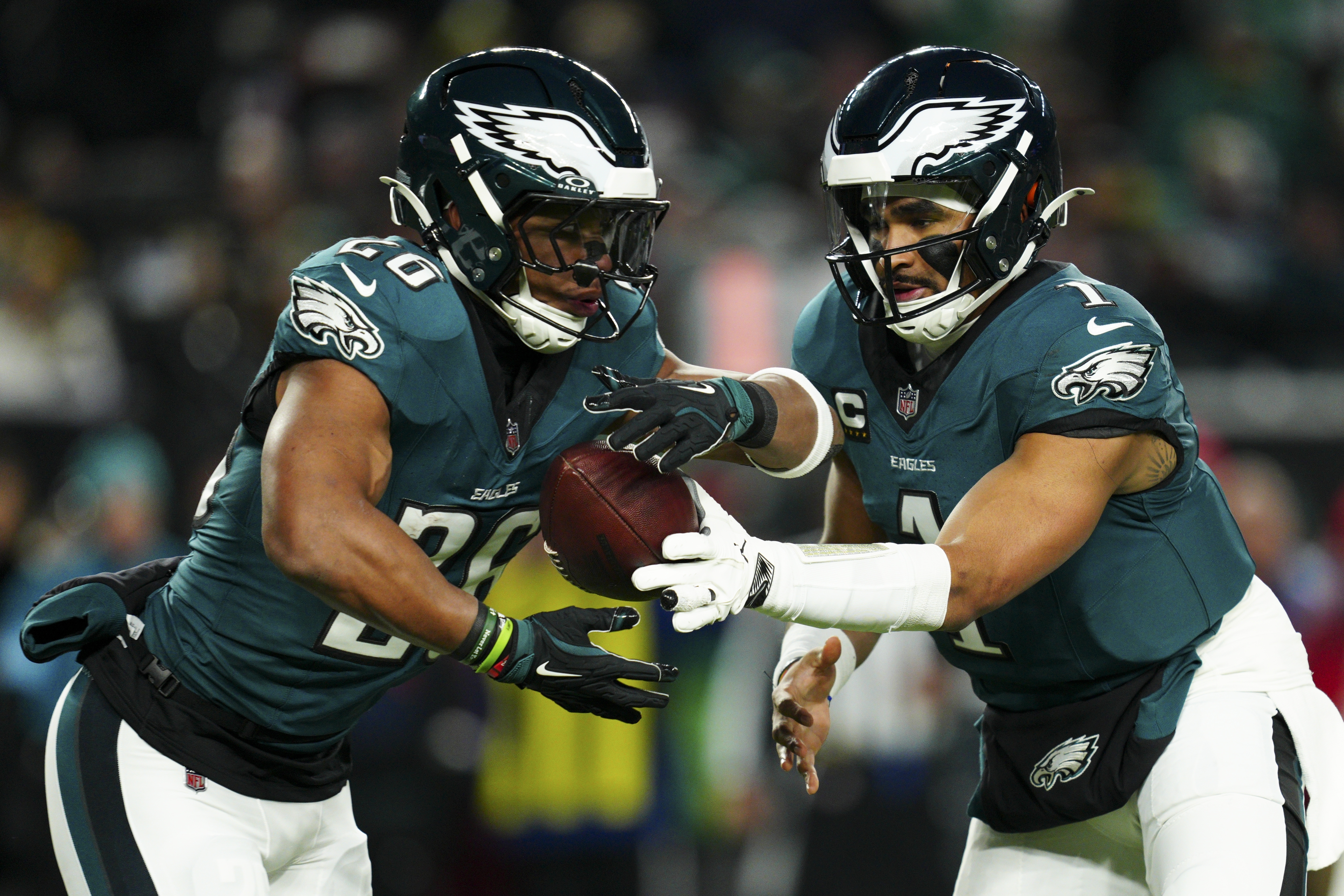 Philadelphia Eagles quarterback Jalen Hurts (1) hands off the ball to Philadelphia Eagles running back Saquon Barkley (26) during the first half of an NFL football game against the Pittsburgh Steelers on Sunday, Dec. 15, 2024, in Philadelphia.
