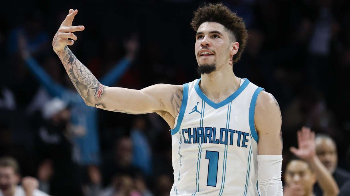 Charlotte Hornets guard LaMelo Ball reacts after making a three point basket against the Miami Heat during the second half of an NBA basketball game in Charlotte, N.C., Wednesday, Nov. 27, 2024.