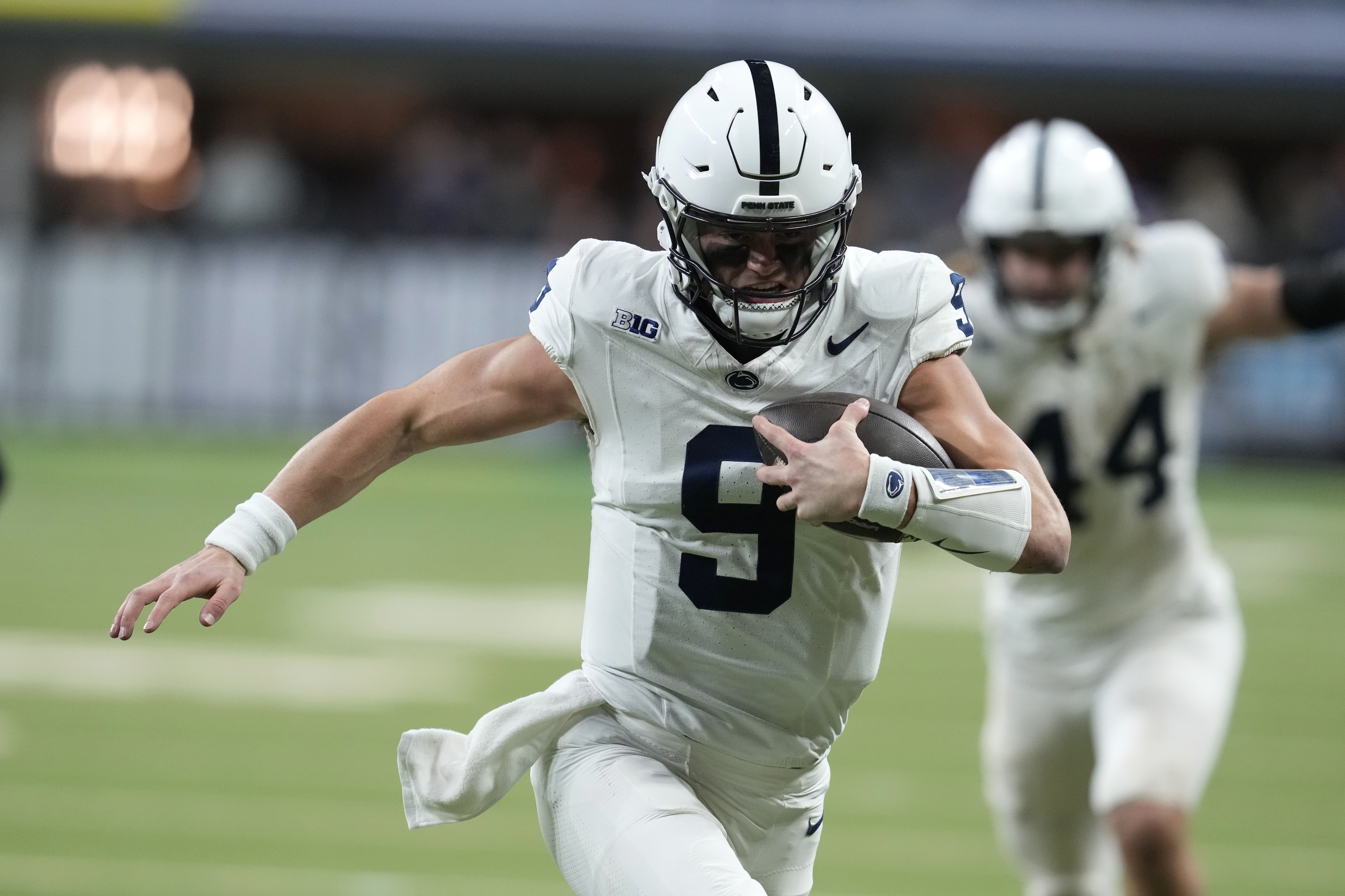 Penn State quarterback Beau Pribula (9) runs up field during the second half of the Big Ten championship NCAA college football game against Oregon, Saturday, Dec. 7, 2024, in Indianapolis.