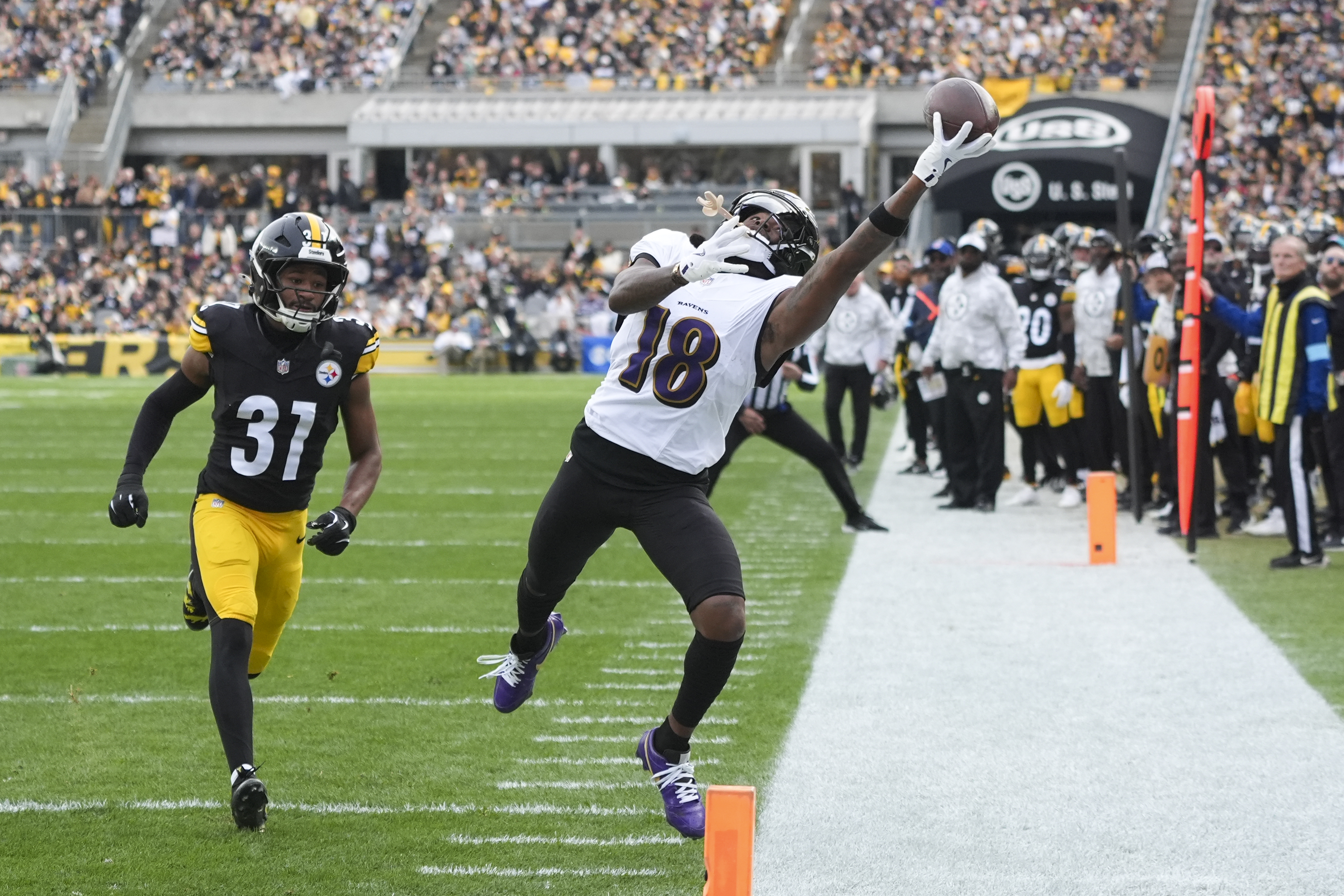 Baltimore Ravens wide receiver Diontae Johnson, right, attempts to catch a pass in front of Pittsburgh Steelers cornerback Beanie Bishop Jr. during the first half of an NFL football game, Sunday, Nov. 17, 2024, in Pittsburgh. 