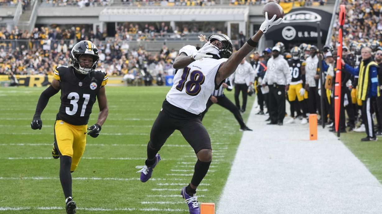 Baltimore Ravens wide receiver Diontae Johnson, right, attempts to catch a pass in front of Pittsburgh Steelers cornerback Beanie Bishop Jr. during the first half of an NFL football game, Sunday, Nov. 17, 2024, in Pittsburgh.