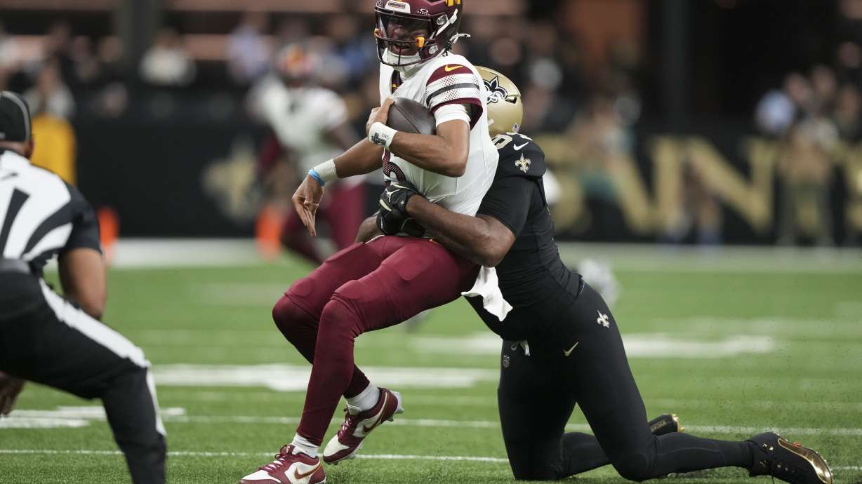 New Orleans Saints defensive end Cameron Jordan (94) sacks Washington Commanders quarterback Jayden Daniels (5) in the first half of an NFL football game in New Orleans, Sunday, Dec. 15, 2024.