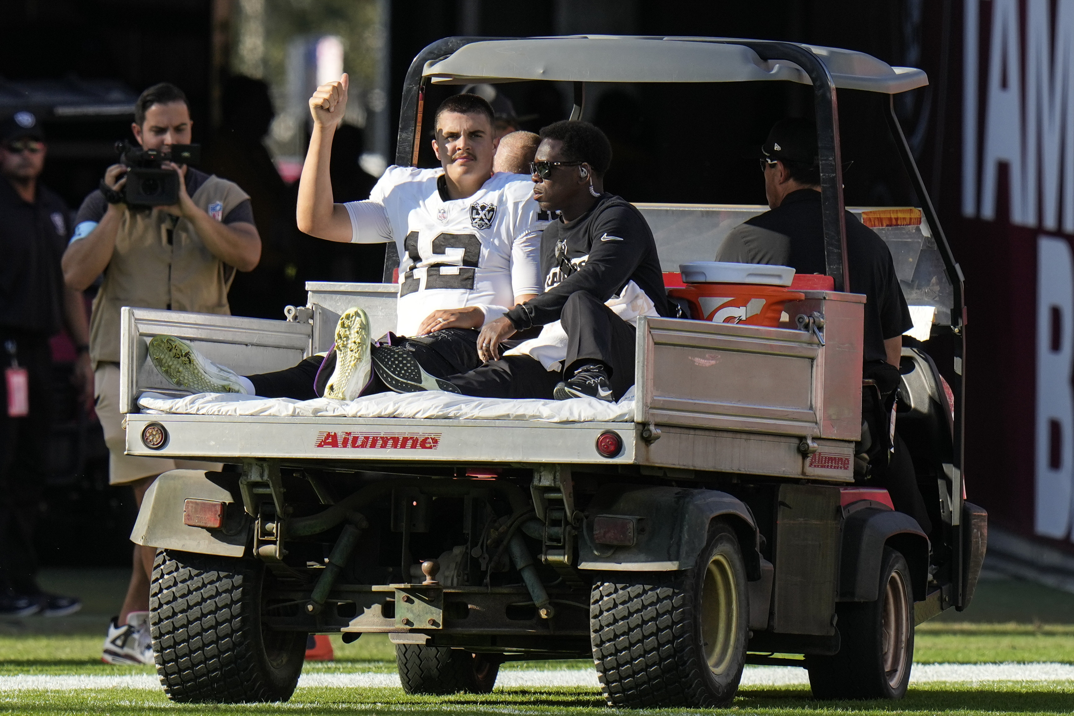 Las Vegas Raiders quarterback Aidan O'Connell (12) is taken off the field after an injury against the Tampa Bay Buccaneers during the second half of an NFL football game, Sunday, Dec. 8, 2024, in Tampa, Fla. 