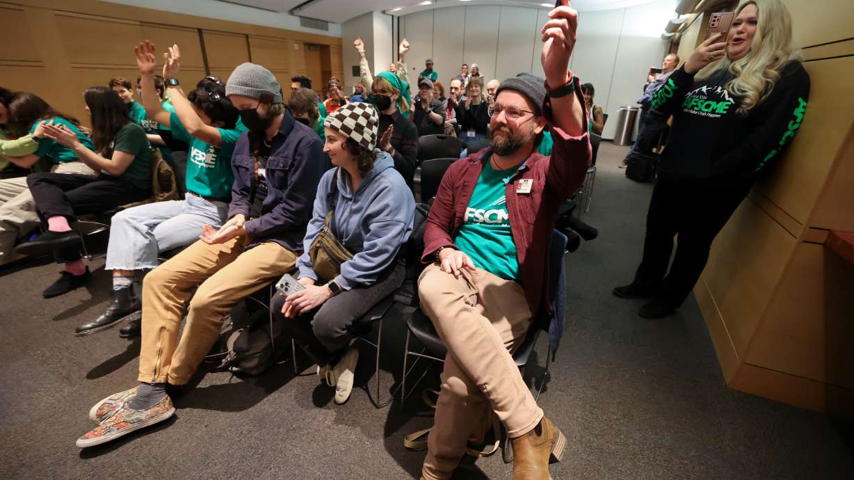 Librarian Bryce Hays and other Salt Lake City Public Library Workers United members react as the Salt Lake City Public Library Board of Directors signals support to allow them to unionize, at the Salt Lake Main Library in Salt Lake City on Monday.