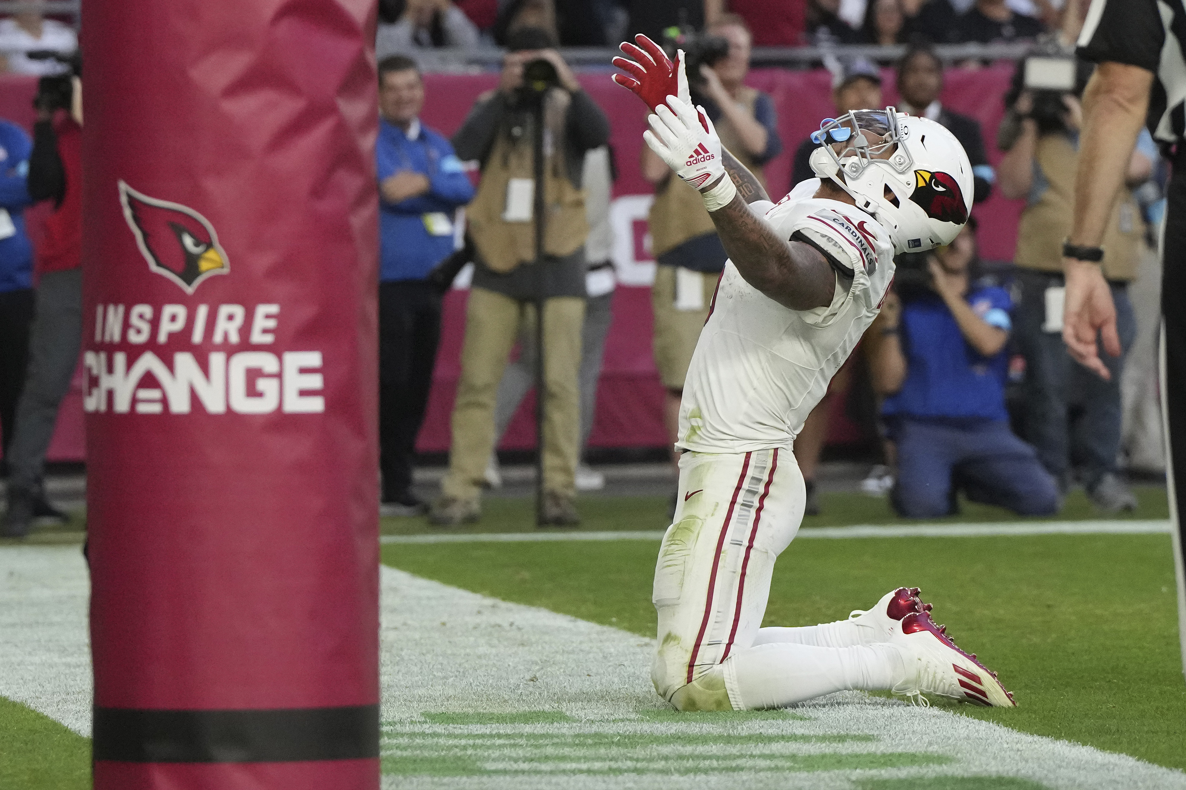 Arizona Cardinals running back James Conner celebrates his touchdown against the New England Patriots during the second half of an NFL football game, Sunday, Dec. 15, 2024, in Glendale, Ariz. 