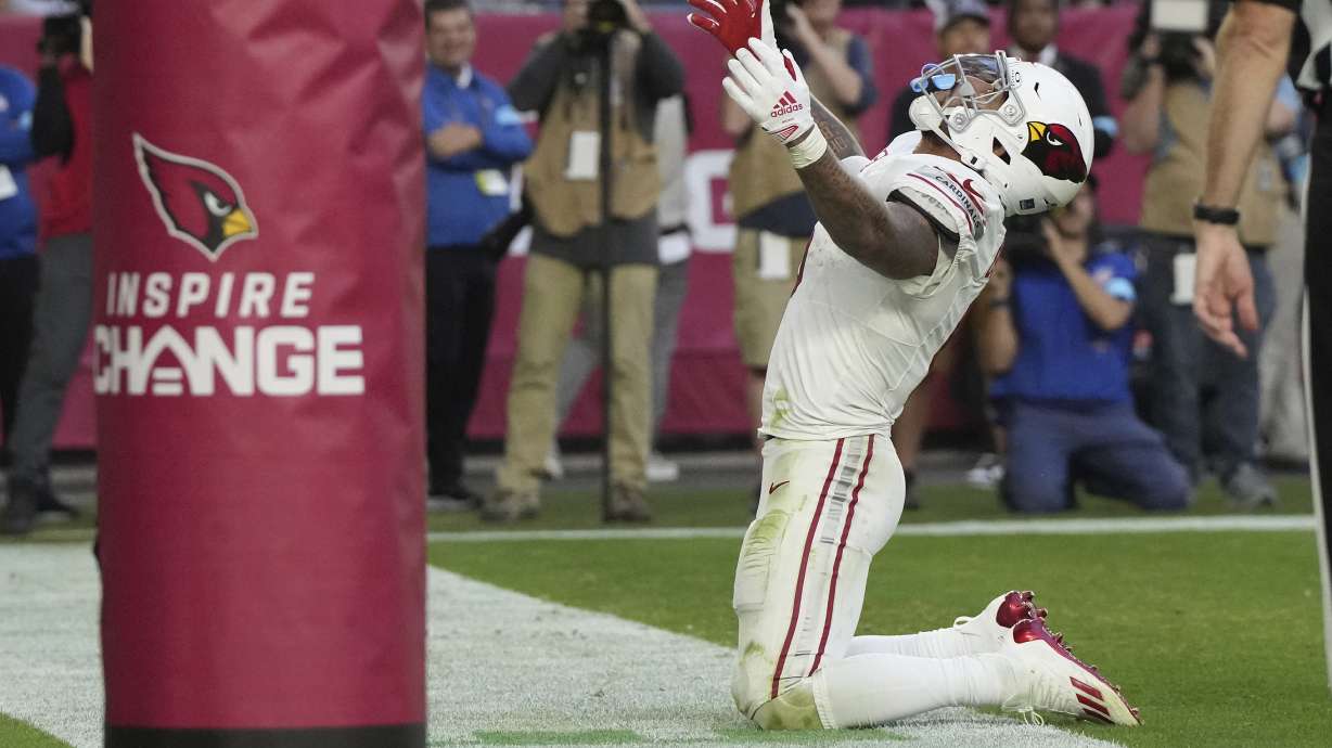 Arizona Cardinals running back James Conner celebrates his touchdown against the New England Patriots during the second half of an NFL football game, Sunday, Dec. 15, 2024, in Glendale, Ariz.