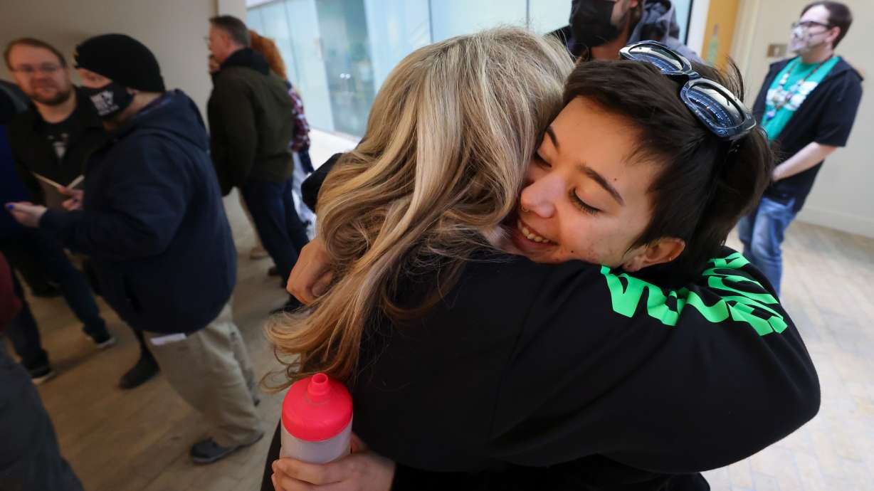 Katy Hagge and Esther Daranciang embrace after the Salt Lake City Public Library board of directors voted to pass a resolution allowing library workers to unionize on Dec. 16, 2024. Salt Lake City approved the library's first collective bargaining agreement on Tuesday.