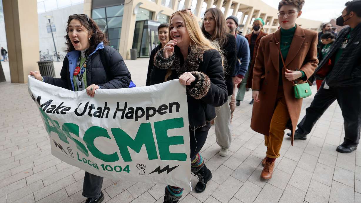 Christina Ordonez and Anna Young walk into The City Library with other united members and supporters ahead of a library board of directors vote on a resolution allowing library workers to unionize in Salt Lake City on Dec. 16, 2024. The Salt Lake City Council voted Tuesday to pass a resolution approving the measure.