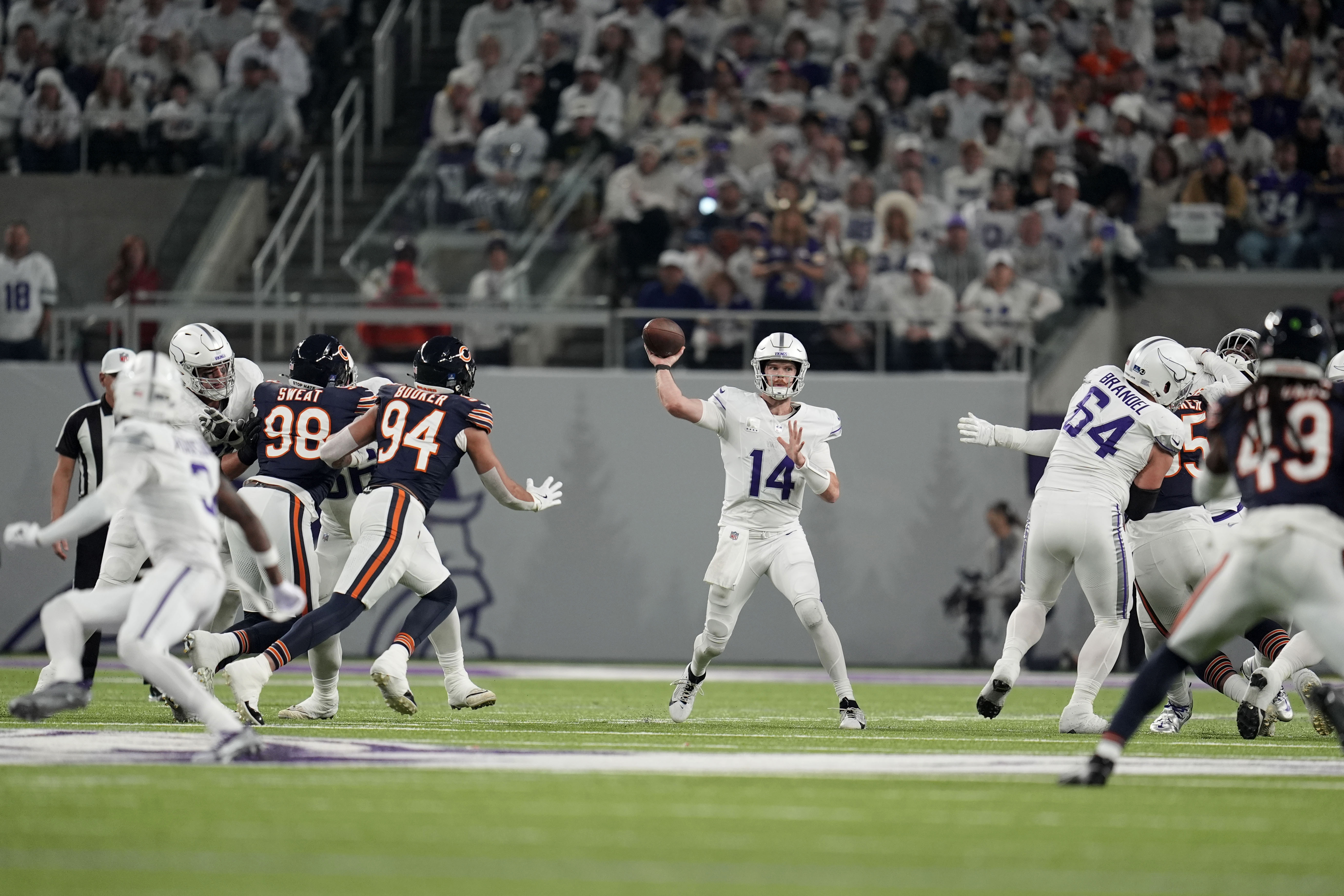 Minnesota Vikings quarterback Sam Darnold (14) throws a pass during the first half of an NFL football game against the Chicago Bears, Monday, Dec. 16, 2024, in Minneapolis. 