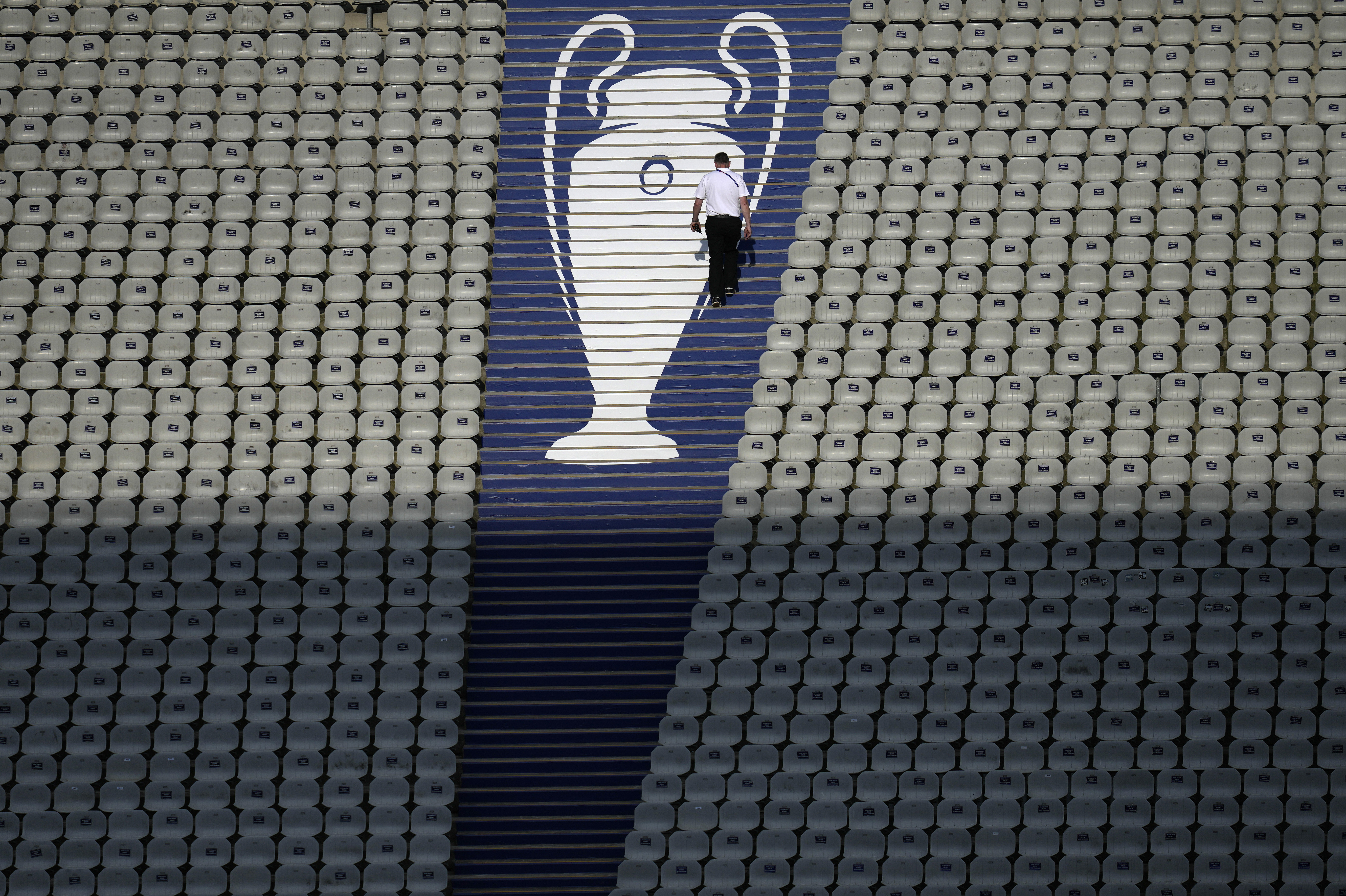 FILE - A security official walks past a Champions League trophy logo during an Inter Milan training session at the Ataturk Olympic Stadium in Istanbul, Turkey, Friday, June 9, 2023. 