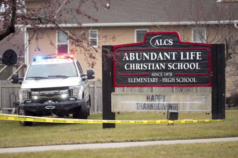 Emergency vehicles are parked outside the Abundant Life Christian School in Madison, Wis., following a shooting, Monday.