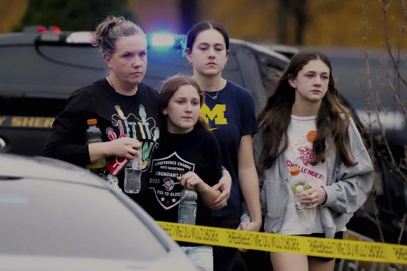 A family leave the shelter after multiple injuries were reported following a shooting at the Abundant Life Christian School, Monday.