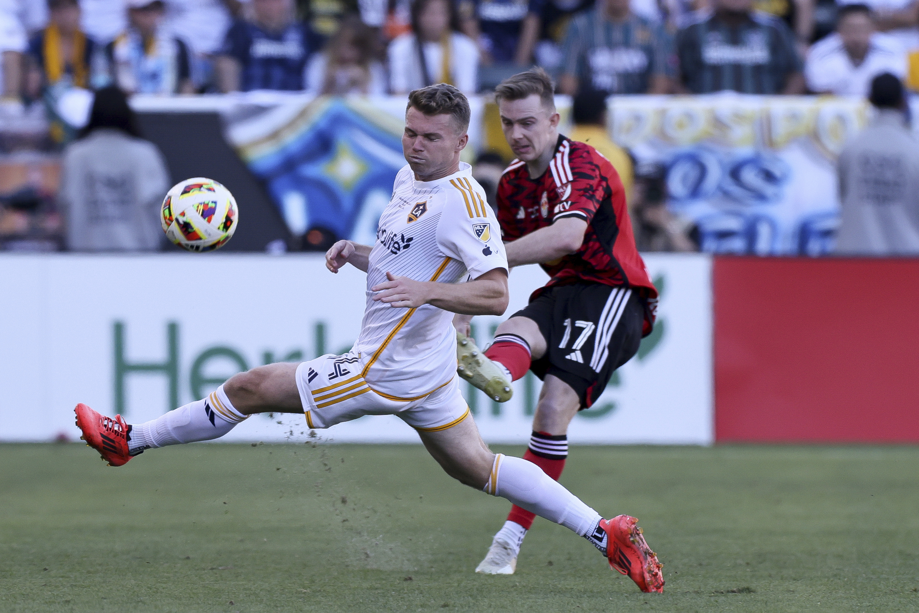 New York Red Bulls midfielder Cameron Harper (17) shoots past Los Angeles Galaxy defender John Nelson (14) during the second half of the MLS Cup championship soccer match Saturday, Dec. 7, 2024, in Carson, Calif.