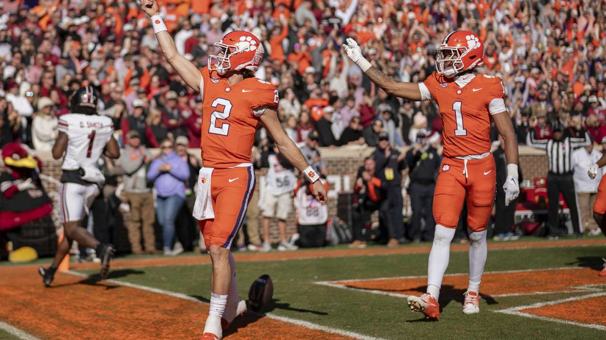 Clemson quarterback Cade Klubnik (2) celebrates his touchdown with wide receiver T.J. Moore (1) in the first half of an NCAA college football game against South Carolina, Saturday, Nov. 30, 2024, in Clemson, S.C.
