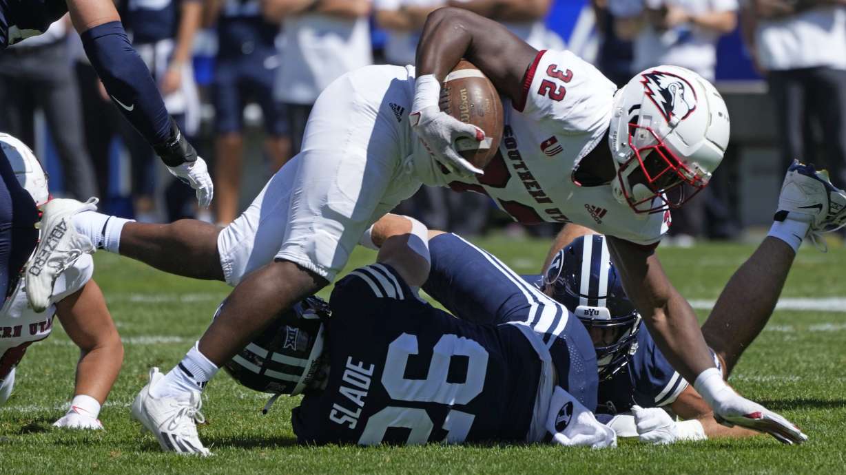 Southern Utah running back Targhee Lambson (32) is tackled by BYU safety Ethan Slade (26) during the first half of an NCAA college football game Saturday, Sept. 9, 2023, in Provo, Utah.