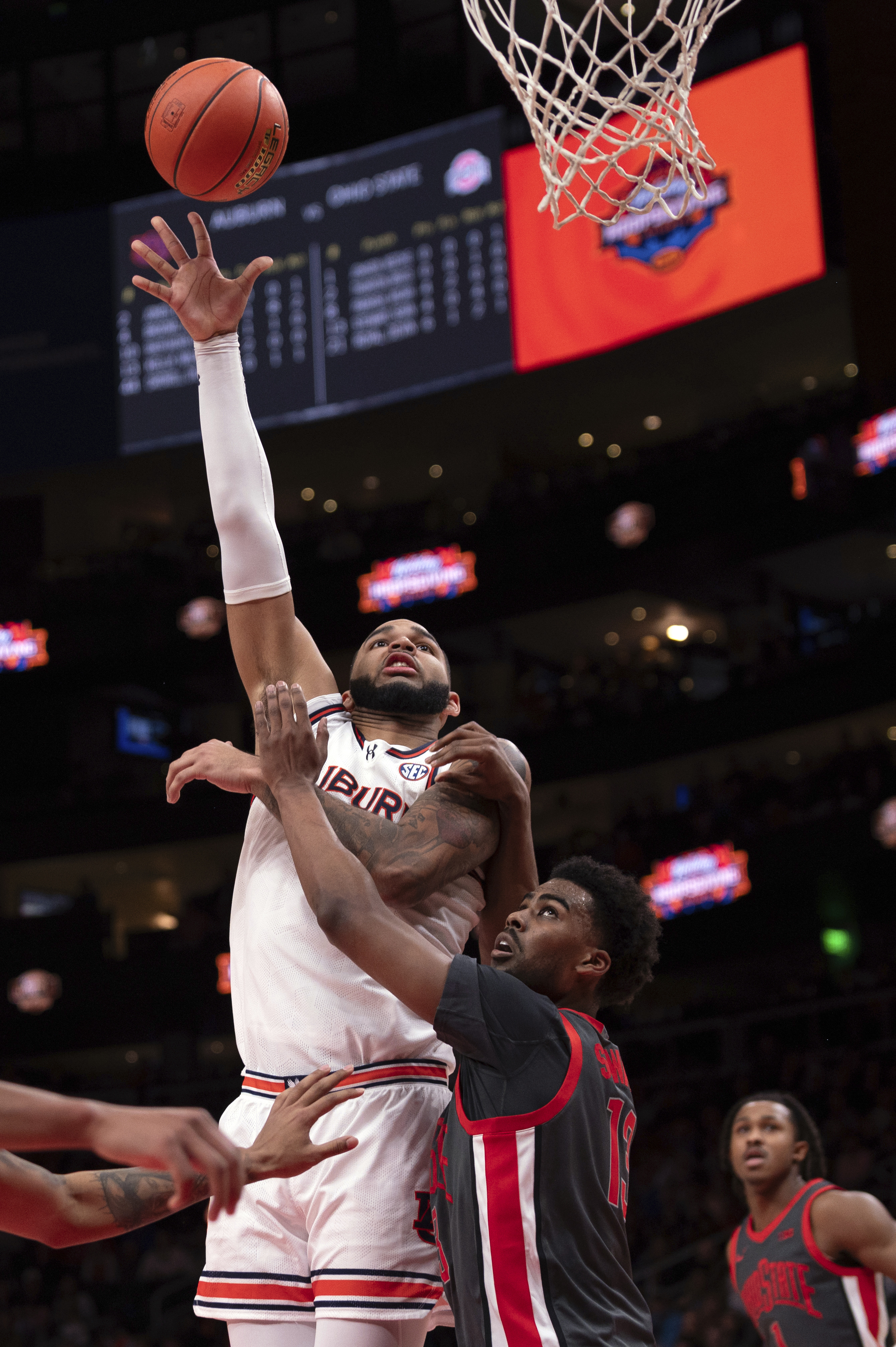 Auburn forward Johni Broome (4) shoots over Ohio State forward Sean Stewart (13) during the first half of an NCAA college basketball game against Ohio State on Saturday, Dec. 14, 2024, in Atlanta. 