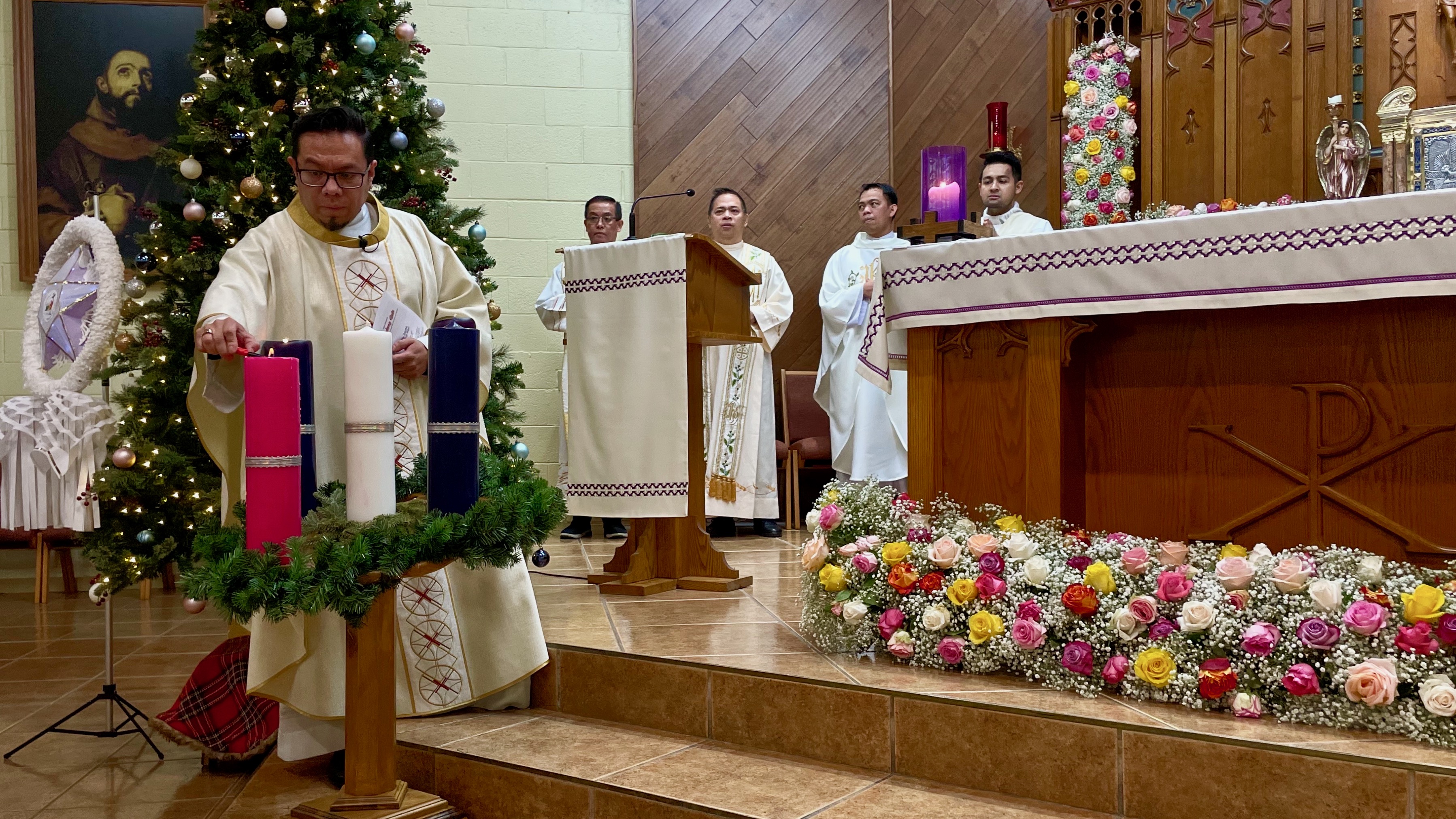 Rev. Jorge Roldan-Sanchez, left, at a Simbang Gabi service held Monday at Our Lady of Guadalupe Catholic Church in Salt Lake City. Simbang Gabi is a Christmastime tradition among Catholic Filipinos.