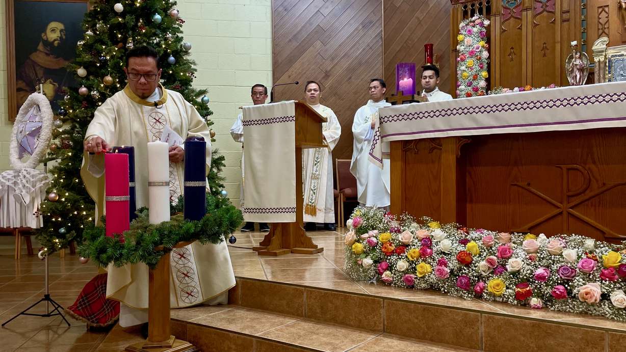 Rev. Jorge Roldan-Sanchez, left, at a Simbang Gabi service held Monday at Our Lady of Guadalupe Catholic Church in Salt Lake City. Simbang Gabi is a Christmastime tradition among Catholic Filipinos.