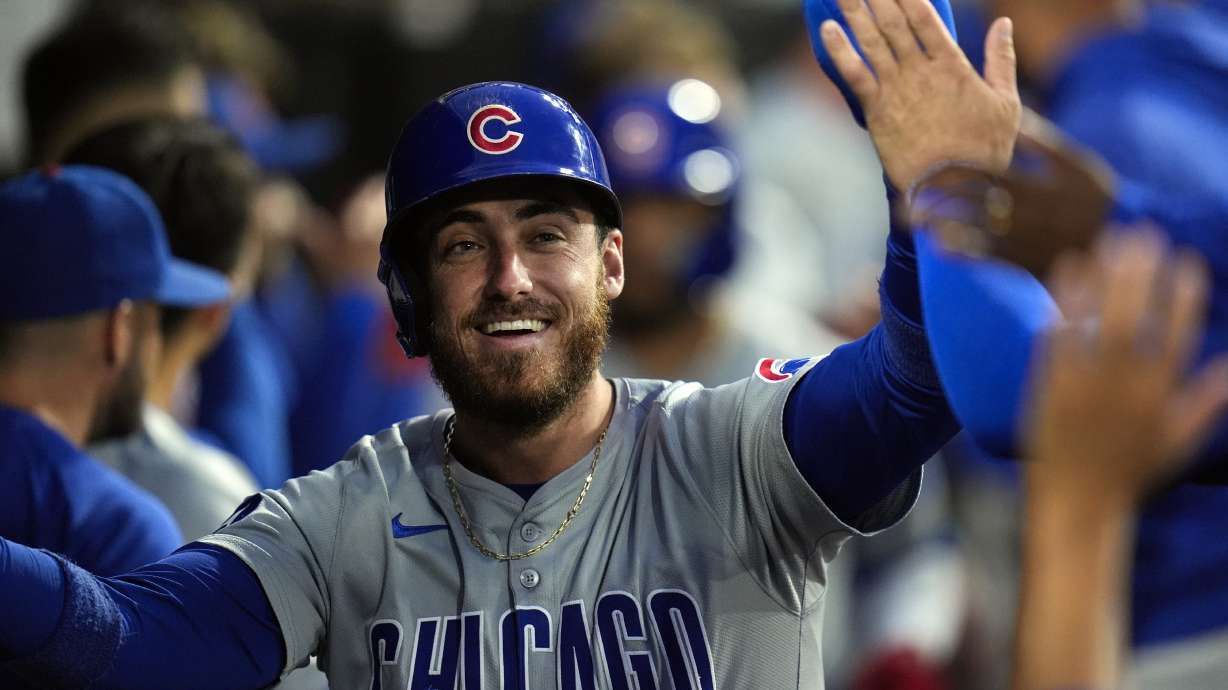 FILE - Chicago Cubs' Cody Bellinger celebrates after scoring on a home run by Isaac Paredes during the third inning of a baseball game against the Chicago White Sox, Friday, Aug. 9, 2024, in Chicago.