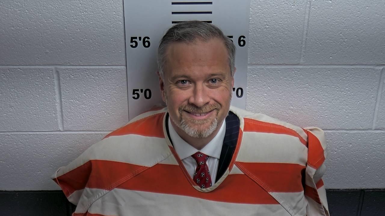 Tennessee District Attorney Chris Stanford was booked into the DeKalb County jail Tuesday after he was accused of recklessly endangering a woman and her three children while pursuing a fugitive.