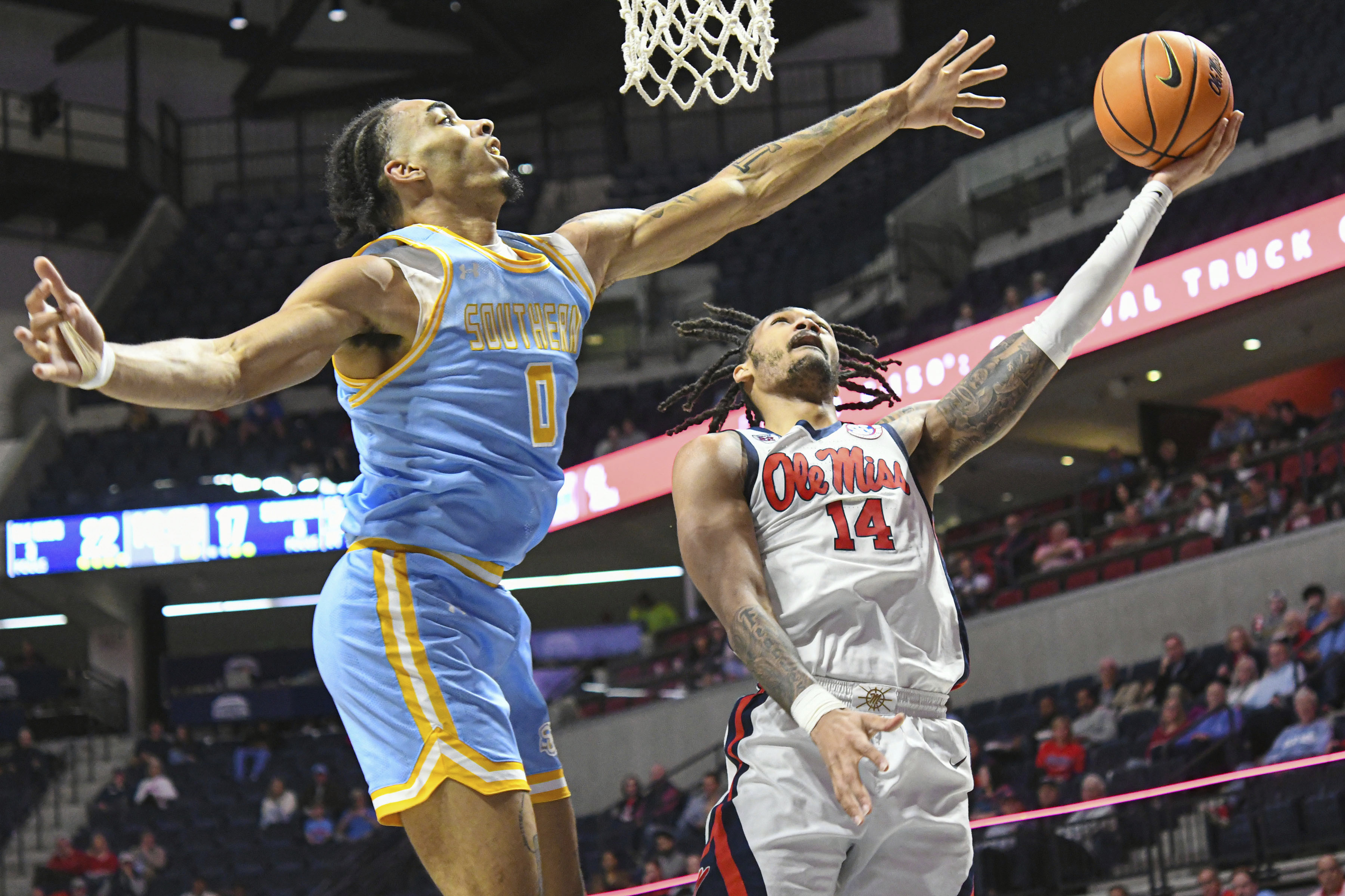 Mississippi guard Dre Davis (14) shoots against Southern University center Brentay Noel (0) during the first half of an NCAA college basketball game in Oxford, Miss., Tuesday, Dec. 17, 2024.