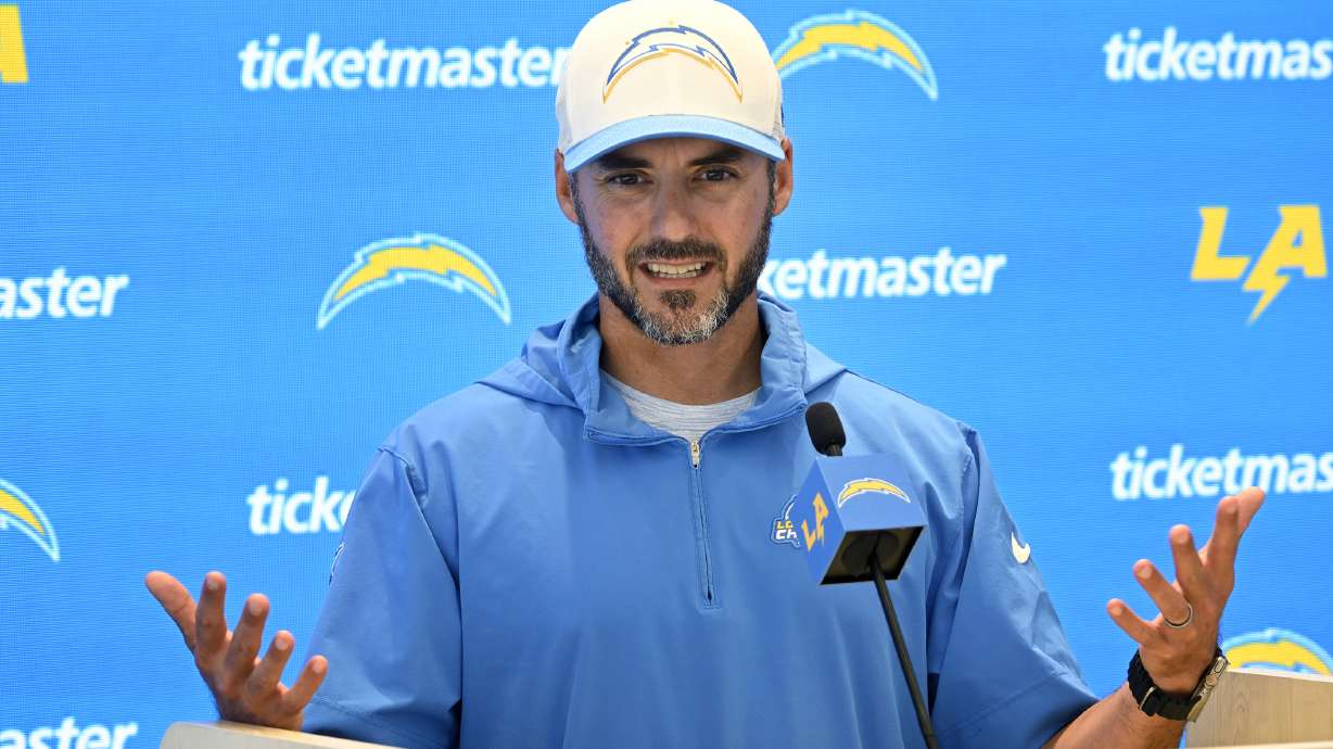 FILE -Los Angeles Chargers defensive coordinator Jesse Minter speaks at a news conference during NFL football training camp Friday, July 26, 2024, in El Segundo, Calif.