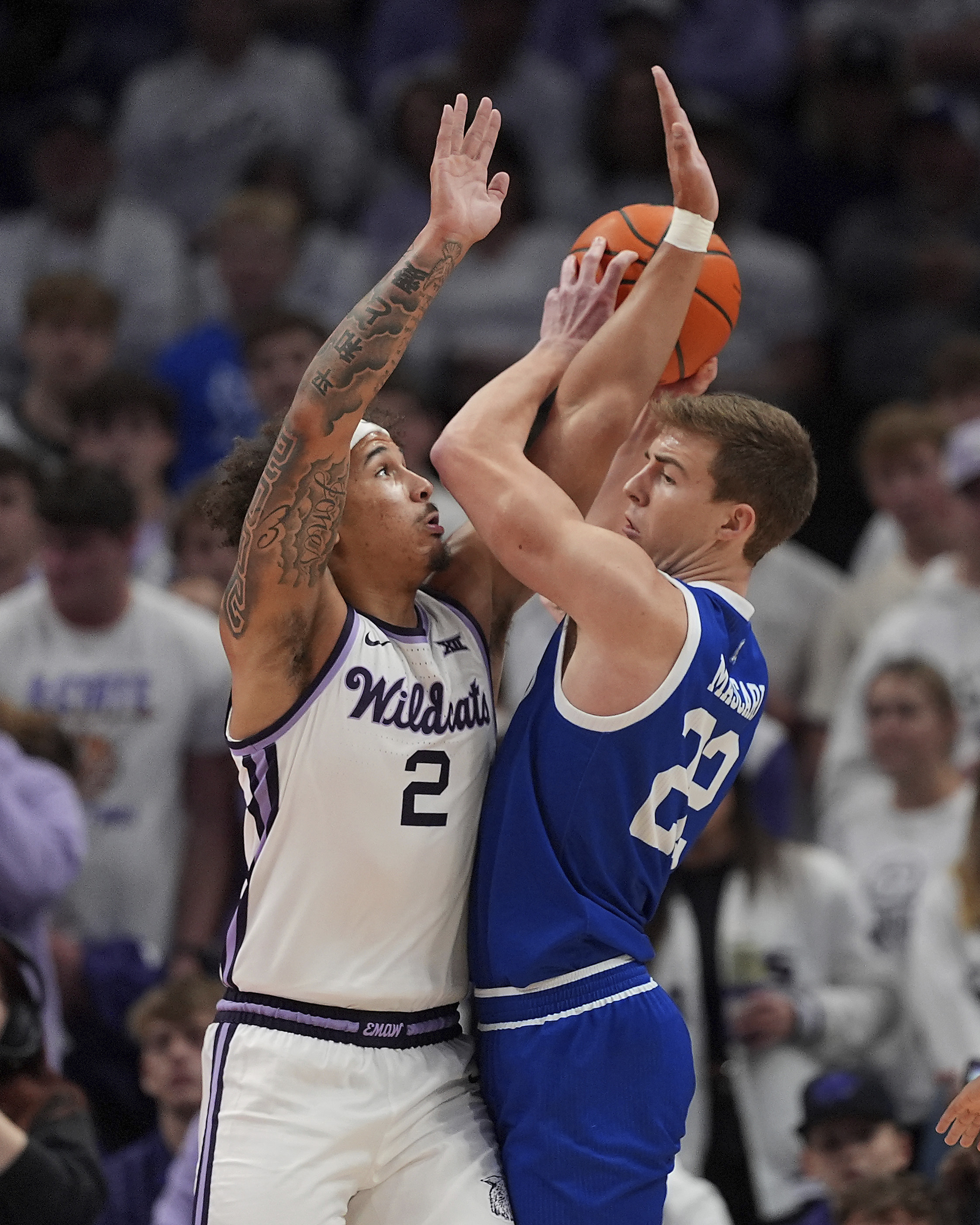 Drake guard Mitch Mascari (22) looks to shoot under pressure from Kansas State guard Max Jones (2) during the first half of an NCAA college basketball game, Tuesday, Dec. 17, 2024, in Kansas City, Mo.
