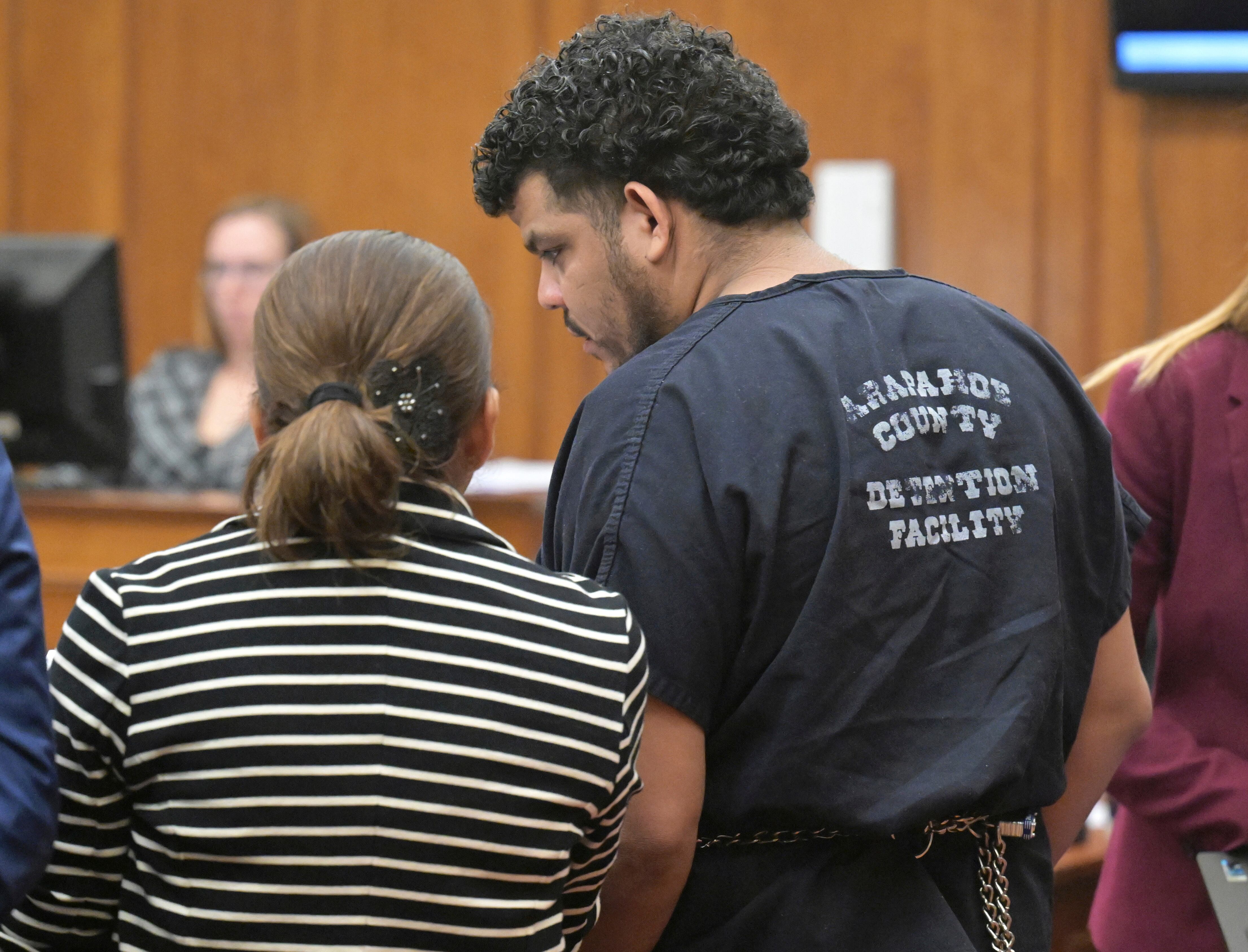 Yoendry Vilchez Medina-Jose, a documented member of Tren de Aragua according to Aurora police, right, talks with his interpreter during an appearance in Arapahoe District Court for a continuation hearing Friday, Oct. 25, 2024, in Centennial, Colo.