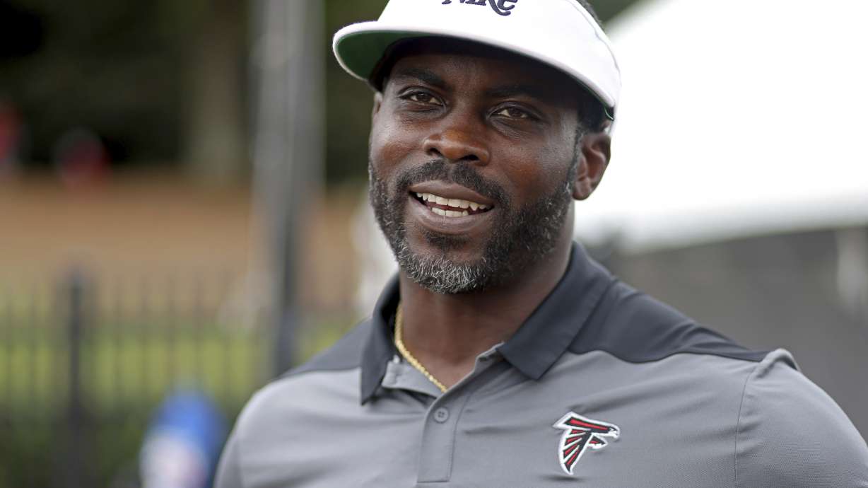 FILE - Former Atlanta Falcons quarterback Michael Vick speaks to members of the media during NFL football training camp at the team's practice facility in Flowery Branch, Ga., Wednesday, Aug. 10, 2022. /Atlanta Journal-Constitution via AP)