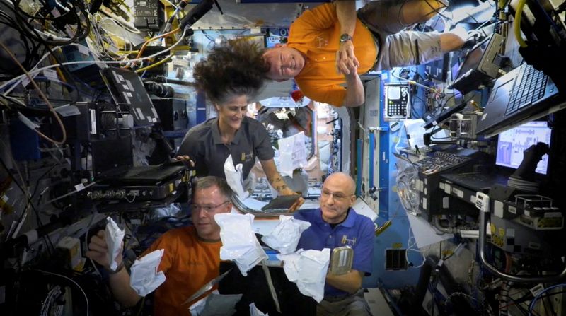 NASA astronauts Sunita Williams, Nick Hague, Barry Wilmore, and Donald Pettit unbox Thanksgiving meals, from the International Space Station in this image released on Nov. 26.