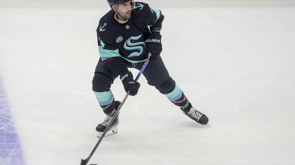 FILE - Seattle Kraken defenseman Justin Schultz moves the puck against the Buffalo Sabres during the third period of an NHL hockey game Monday, March 18, 2024, in Seattle.