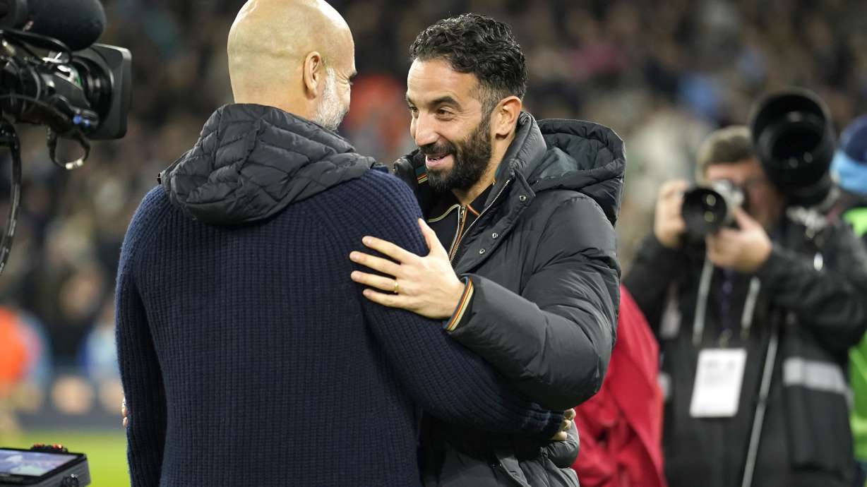 Manchester City's head coach Pep Guardiola, left, and Manchester United's manager RĂºben Amorim meet ahead the English Premier League soccer match between Manchester City and Manchester United at the Etihad Stadium in Manchester, Sunday, Dec. 15, 2024.
