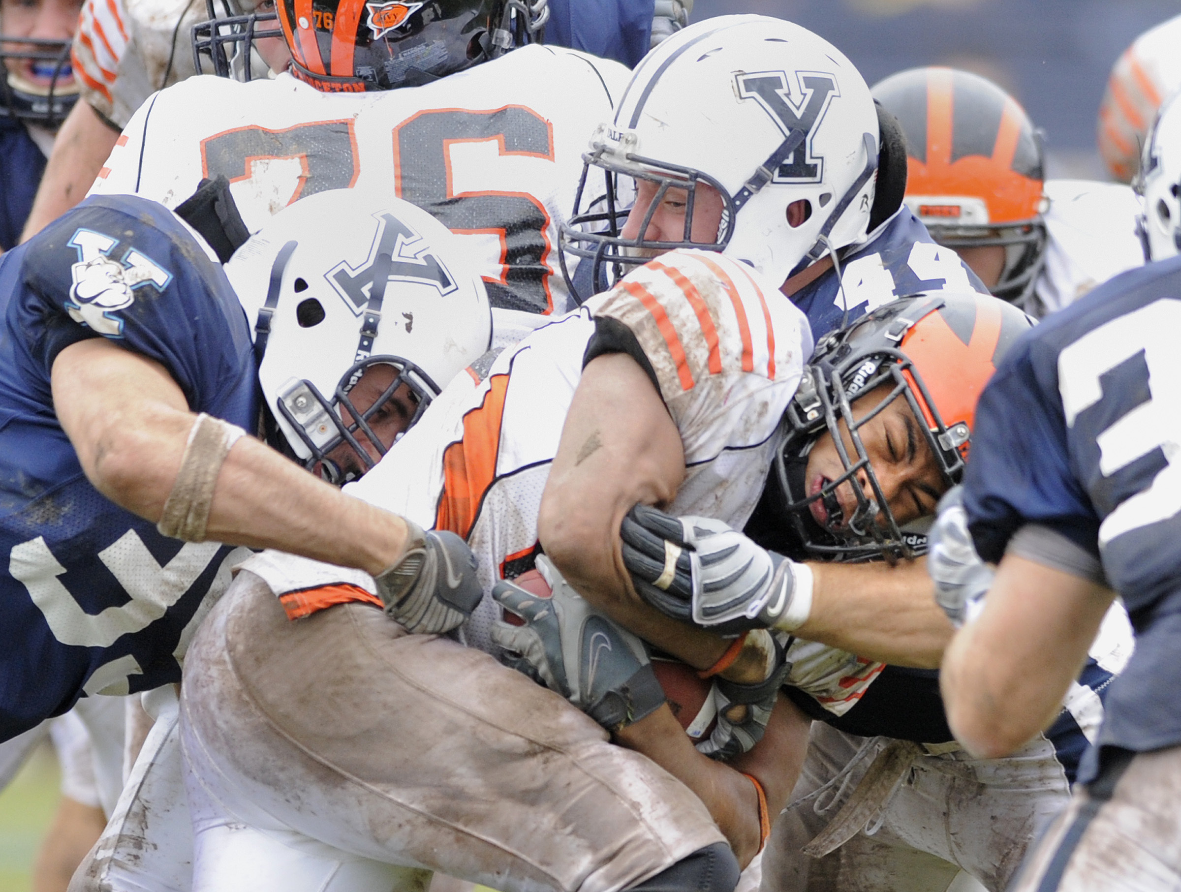 FILE - Princeton's Jordan Culbreath, center, fights for an extra yard as he is tackled by Yale's Jay Pilkerton, left, Bobby Abare, center, and Brady Hart, right during Yale's 14-0 victory in an NCAA college football game in New Haven, Conn., on Saturday, Nov. 15, 2008.