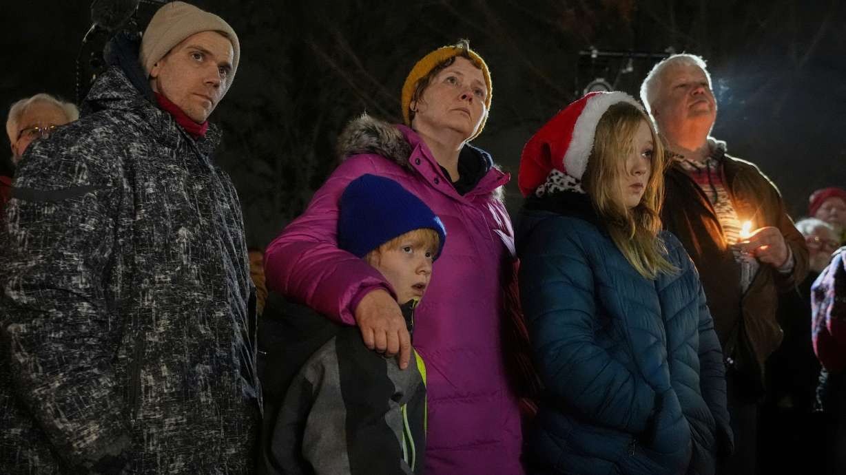 Supporters hold candles during a candlelight vigil Tuesday outside the Wisconsin Capitol in Madison, Wis.