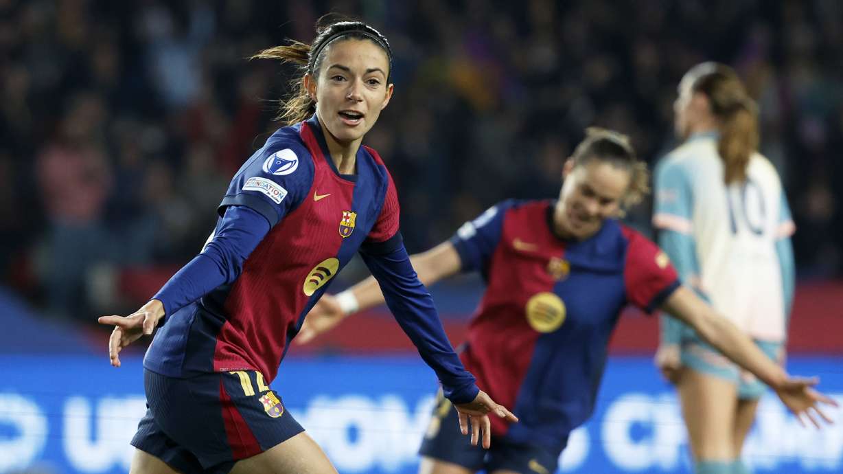 Barcelona's Aitana Bonmati, left, celebrates after scoring her side's second goal during the women's Champions League group D soccer match between FC Barcelona and Manchester City at the Olympic Stadium in Barcelona, Spain, Wednesday, Dec. 18, 2024.