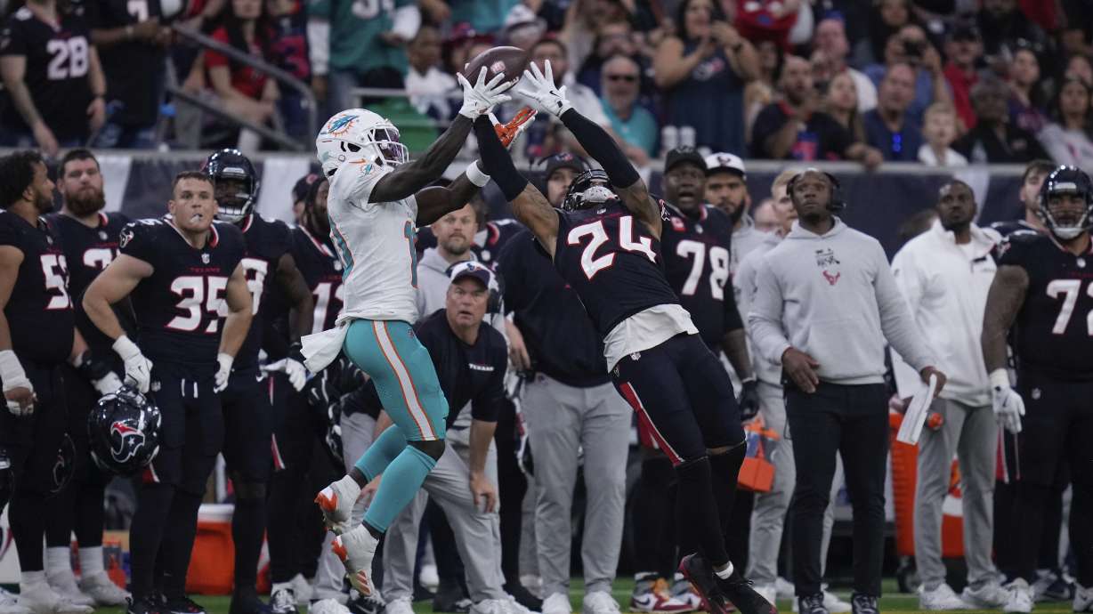 Houston Texans cornerback Derek Stingley Jr. (24) intercepts a pass intended for Miami Dolphins wide receiver Tyreek Hill (10) during the second half of an NFL football game Sunday, Dec. 15, 2024, in Houston.