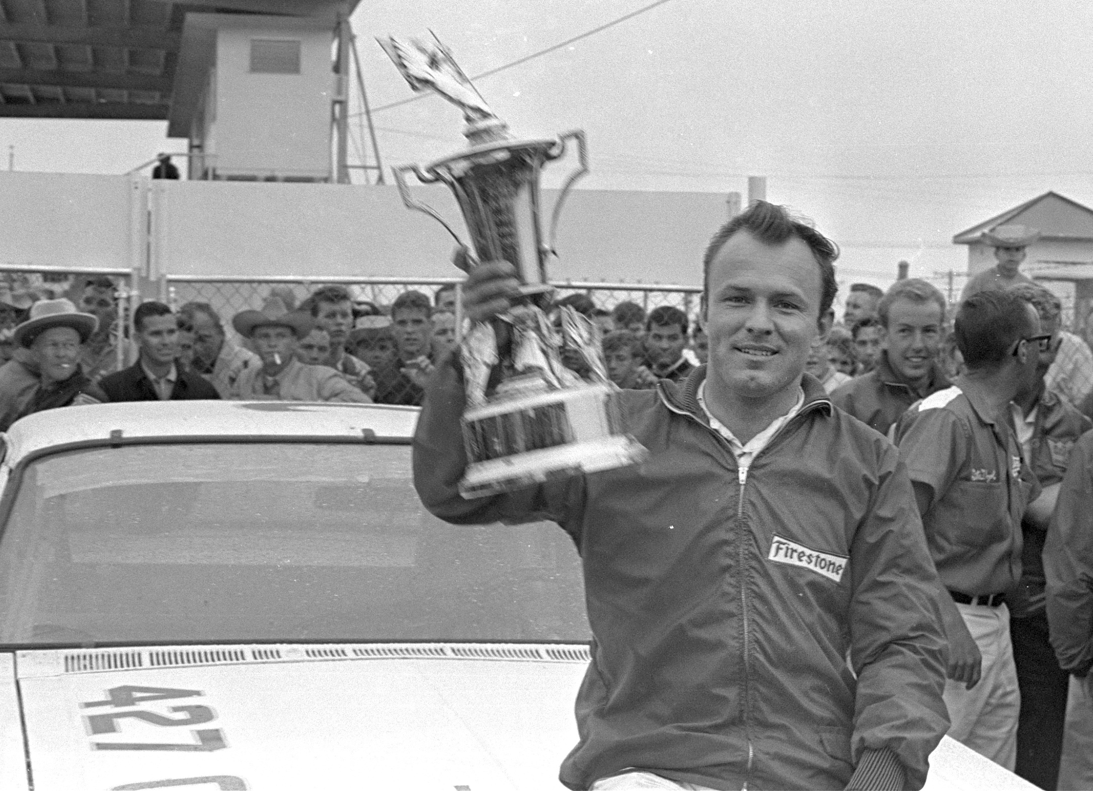 FILE - In this Feb. 14, 1965, file photo, Fred Lorenzen, of Elmhurst, Ill., gives a victory wave after winning the Daytona 500 mile stock car auto race which was halted by rain at the end of 133 laps, in Daytona Beach, Fla. 